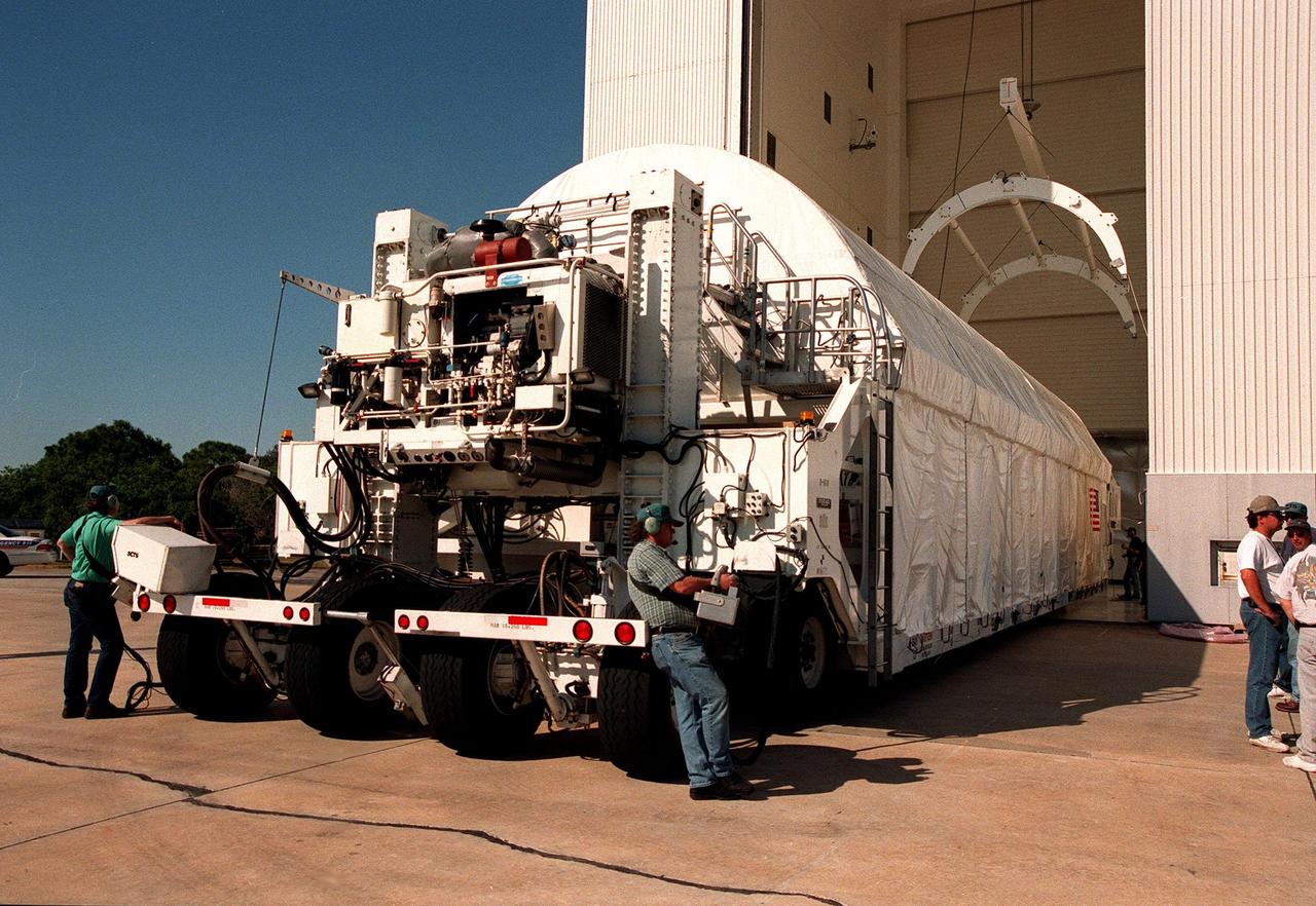 Cradled in the cargo hold of a tractor-trailer rig called the Space Cargo Transportation System, the Chandra X-ray Observatory waits to be moved inside the Vertical Processing Facility (VPF). Chandra arrived at the Shuttle Landing Facility on Thursday, Feb. 4, aboard an Air Force C-5 Galaxy aircraft. In the VPF, the telescope will undergo final installation of associated electronic components; it will also be tested, fueled and mated with the Inertial Upper Stage booster. A set of integrated tests will follow. Chandra is scheduled for launch July 9 aboard Space Shuttle Columbia, on mission STS-93 . Formerly called the Advanced X-ray Astrophysics Facility, Chandra comprises three major elements: the spacecraft, the science instrument module (SIM), and the world's most powerful X-ray telescope. Chandra will allow scientists from around the world to see previously invisible black holes and high-temperature gas clouds, giving the observatory the potential to rewrite the books on the structure and evolution of our universe