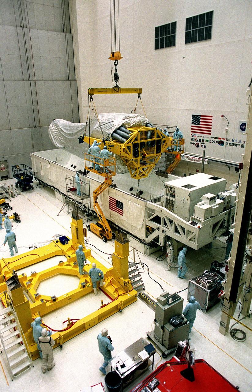 Inside the Vertical Processing Facility (VPF), workers begin lifting the Chandra X-ray Observatory out of its protective container. While in the VPF, the telescope will undergo final installation of associated electronic components; it will also be tested, fueled and mated with the Inertial Upper Stage booster. A set of integrated tests will follow. Chandra is scheduled for launch July 9 aboard Space Shuttle Columbia, on mission STS-93 . Formerly called the Advanced X-ray Astrophysics Facility, Chandra comprises three major elements: the spacecraft, the science instrument module (SIM), and the world's most powerful X-ray telescope. Chandra will allow scientists from around the world to see previously invisible black holes and high-temperature gas clouds, giving the observatory the potential to rewrite the books on the structure and evolution of our universe