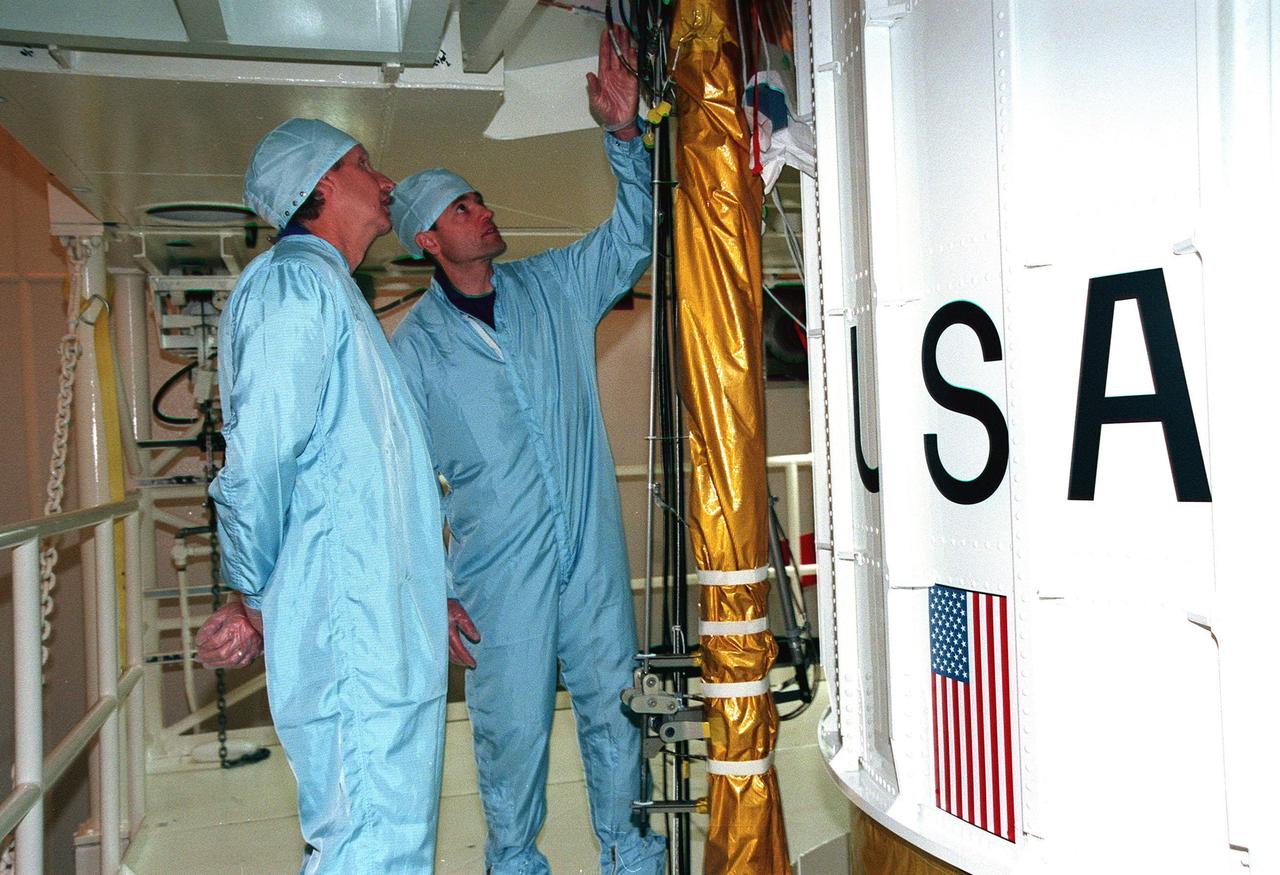 In the Solid Motor Assembly Building, Cape Canaveral Air Station, STS-93 Pilot Jeffrey S. Ashby and Mission Specialist Steven A. Hawley look over the Inertial Upper Stage booster being readied for their mission. Other crew members (not shown) are Commander Eileen Collins and Mission Specialists Catherine G. Coleman and Michel Tognini of France, who represents the Centre National d'Etudes Spatiales (CNES). STS-93, scheduled to launch July 9 aboard Space Shuttle Columbia, has the primary mission of the deployment of the Chandra X-ray Observatory. Formerly called the Advanced X-ray Astrophysics Facility, Chandra comprises three major elements: the spacecraft, the science instrument module (SIM), and the world's most powerful X-ray telescope. Chandra will allow scientists from around the world to see previously invisible black holes and high-temperature gas clouds, giving the observatory the potential to rewrite the books on the structure and evolution of our universe