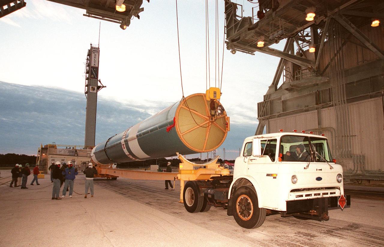 The first stage of a Boeing Delta II rocket is raised off a truck bed before being lifted into place on the tower at Launch Complex 17, Cape Canaveral Air Station. The rocket will carry the Stardust spacecraft into space for a close encounter with the comet Wild 2 in January 2004. Using a medium called aerogel, it will capture comet particles flying off the nucleus of the comet, plus collect interstellar dust for later analysis. The collected samples will return to Earth in a Sample Return Capsule to be jettisoned as Stardust swings by Earth in January 2006. Stardust is scheduled to be launched on Feb. 6, 1999