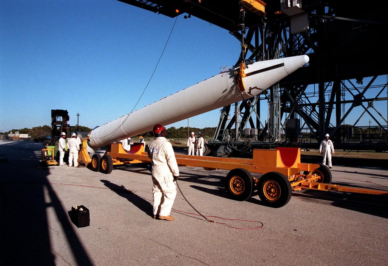 A solid rocket booster is lifted off a transport vehicle for its transfer to the mobile launch tower at Pad 17A, Cape Canaveral Air Station. It will be mated with a Boeing Delta II rocket that will carry the Stardust spacecraft into space for a close encounter with the comet Wild 2 in January 2004. Using a medium called aerogel, Stardust will capture comet particles flying off the nucleus of the comet, plus collect interstellar dust for later analysis. The collected samples will return to Earth in a sample return capsule to be jettisoned as Stardust swings by Earth in January 2006. Stardust is scheduled to be launched on Feb. 6, 1999
