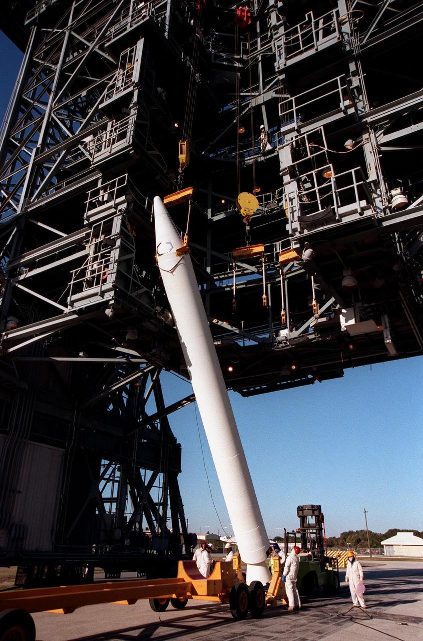 A solid rocket booster is raised to a vertical position before lifting it up the mobile launch tower at Pad 17A, Cape Canaveral Air Station. It will be mated with a Boeing Delta II rocket that will carry the Stardust spacecraft into space for a close encounter with the comet Wild 2 in January 2004. Using a medium called aerogel, Stardust will capture comet particles flying off the nucleus of the comet, plus collect interstellar dust for later analysis. The collected samples will return to Earth in a sample return capsule to be jettisoned as Stardust swings by Earth in January 2006. Stardust is scheduled to be launched on Feb. 6, 1999