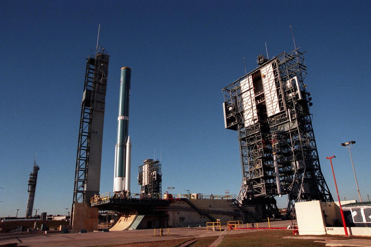 A Boeing Delta II rocket sits on Launch Pad 17A (left), Cape Canaveral Air Station, before mating with its final Solid Rocket Booster, in the tower at right. In the background is Pad 17B with its two launch tower components. The Delta II rocket will carry the Stardust satellite into space for a close encounter with the comet Wild 2 in January 2004. Using a medium called aerogel, Stardust will capture comet particles flying off the nucleus of the comet, plus collect interstellar dust for later analysis. The collected samples will return to Earth in a Sample Return Capsule to be jettisoned as Stardust swings by Earth in January 2006. Stardust is scheduled to be launched on Feb. 6, 1999
