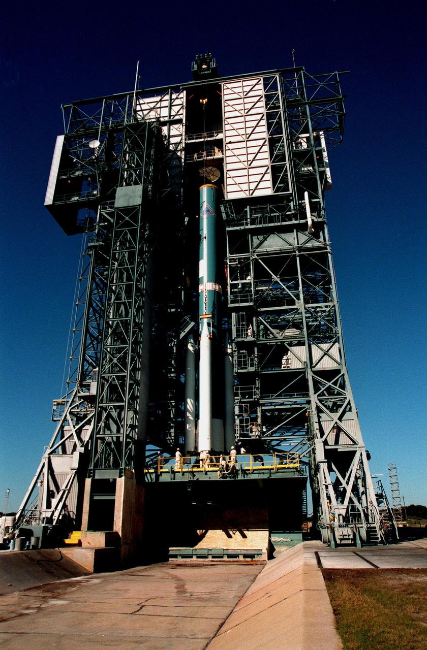 At Pad 17A, Cape Canaveral Air Station, a Boeing Delta II rocket waits with its four solid rocket boosters for final preparations to launch the Stardust satellite on Feb. 6, 1999. The rocket will carry Stardust into space for a close encounter with the comet Wild 2 in January 2004. Using a medium called aerogel, Stardust will capture comet particles flying off the nucleus of the comet, plus collect interstellar dust for later analysis. The collected samples will return to Earth in a Sample Return Capsule to be jettisoned as Stardust swings by Earth in January 2006
