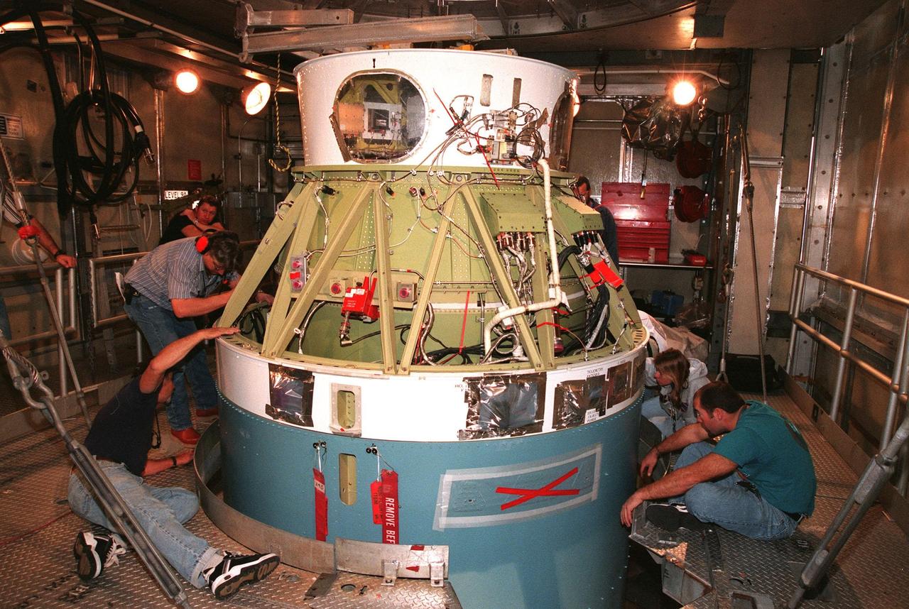 Workers at Pad 17A, Cape Canaveral Air Station, ensure the successful mating of the second stage of a Boeing Delta II rocket with the first stage below it. The rocket is targeted for launch on Feb. 6, carrying the <a href="http://www-pao.ksc.nasa.gov/kscpao/captions/subjects/stardust.htm">Stardust </a> spacecraft into space for a close encounter with the comet Wild 2 in January 2004. Using a substance called aerogel, Stardust will capture comet particles flying off the nucleus of the comet, plus collect interstellar dust for later analysis. The collected samples will return to Earth in a sample return capsule to be jettisoned as Stardust swings by Earth in January 2006