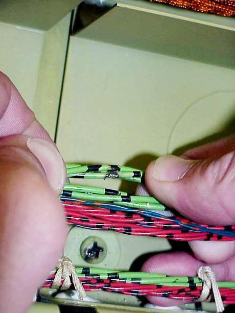 KENNEDY SPACE CENTER, FLA. -- A wire damaged by abrasion from the head of a screw (seen below the bundle) was found during electrical wiring inspections in Columbia's payload bay. During launch of Columbia on mission STS-93, a damaged wire caused a short circuit in two separate main engine controllers. As a result of the findings, Shuttle program managers have decided to conduct inspections of the wiring in Endeavour's payload bay before its next mission, STS-99. The inspection and possible repair work will lead to a delayed launch date no earlier than Oct.7. The primary payload of the mission is the Shuttle Radar Topography Mission, a specially modified radar system that will gather data for the most accurate and complete topographic map of the Earth's surface that has ever been assembled