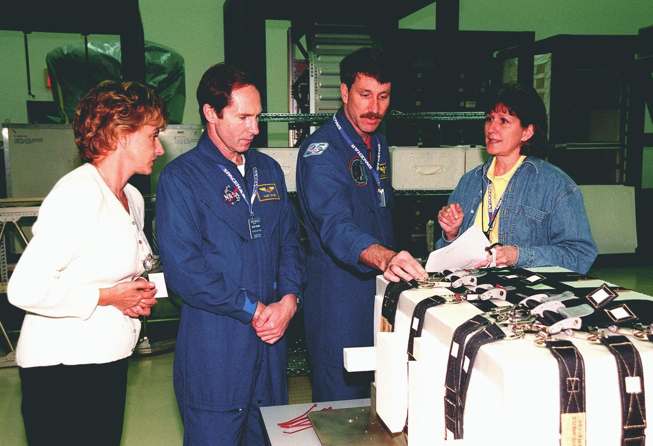 KENNEDY SPACE CENTER, FLA. -- During a payload Interface Verification Test (IVT) in the SPACEHAB Facility, STS-96 Mission Specialist Valery Tokarev of Russia (second from left) and Commander Kent Rominger learn about the Sequential Shunt Unit (SSU) in front of them from Lynn Ashby (far right), with Johnson Space Center. At the far left looking on is TTI interpreter Valentina Maydell. Other crew members at KSC for the IVT are Pilot Rick Husband and Mission Specialists Ellen Ochoa, Tamara Jernigan, Dan Barry and Julie Payette. The SSU is part of the cargo on Mission STS-96, which carries the SPACEHAB Logistics Double Module, with equipment to further outfit the International Space Station service module and equipment that can be off-loaded from the early U.S. assembly flights. The SPACEHAB carries internal logistics and resupply cargo for station outfitting, plus an external Russian cargo crane to be mounted to the exterior of the Russian station segment and used to perform space walking maintenance activities. The double module stowage provides capacity of up to 10,000 lbs. with the ability to accommodate powered payloads, four external rooftop stowage locations, four double-rack locations (two powered), up to 61 bulkhead-mounted middeck locker locations, and floor storage for large unique items and Soft Stowage. STS-96 is targeted to launch May 20 about 9:32 a.m