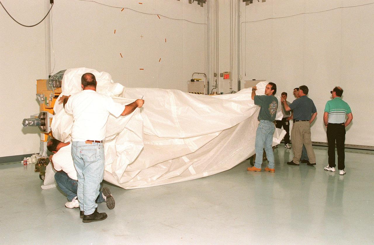 The Canadian Space Agency's (CSA) Space Station Remote Manipulator System (SSRMS) arrives at the Space Station Processing Facility at KSC to begin a campaign of prelaunch processing activities. CSA's first contribution to the International Space Station (ISS), the SSRMS is the primary means of transferring payloads between the orbiter payload bay and the ISS for assembly. The 56-foot-long robotic arm includes two 12-foot booms joined by a hinge. Seven joints on the arm allow highly flexible and precise movement. Latching End Effectors are mounted on each end of the arm for grappling. Video cameras mounted on the booms and end effectors will give astronauts maximum visibility for operations and maintenance tasks on the ISS. The SSRMS is scheduled to be launched aboard Space Shuttle Endeavour on STS-100, currently planned for July 2000