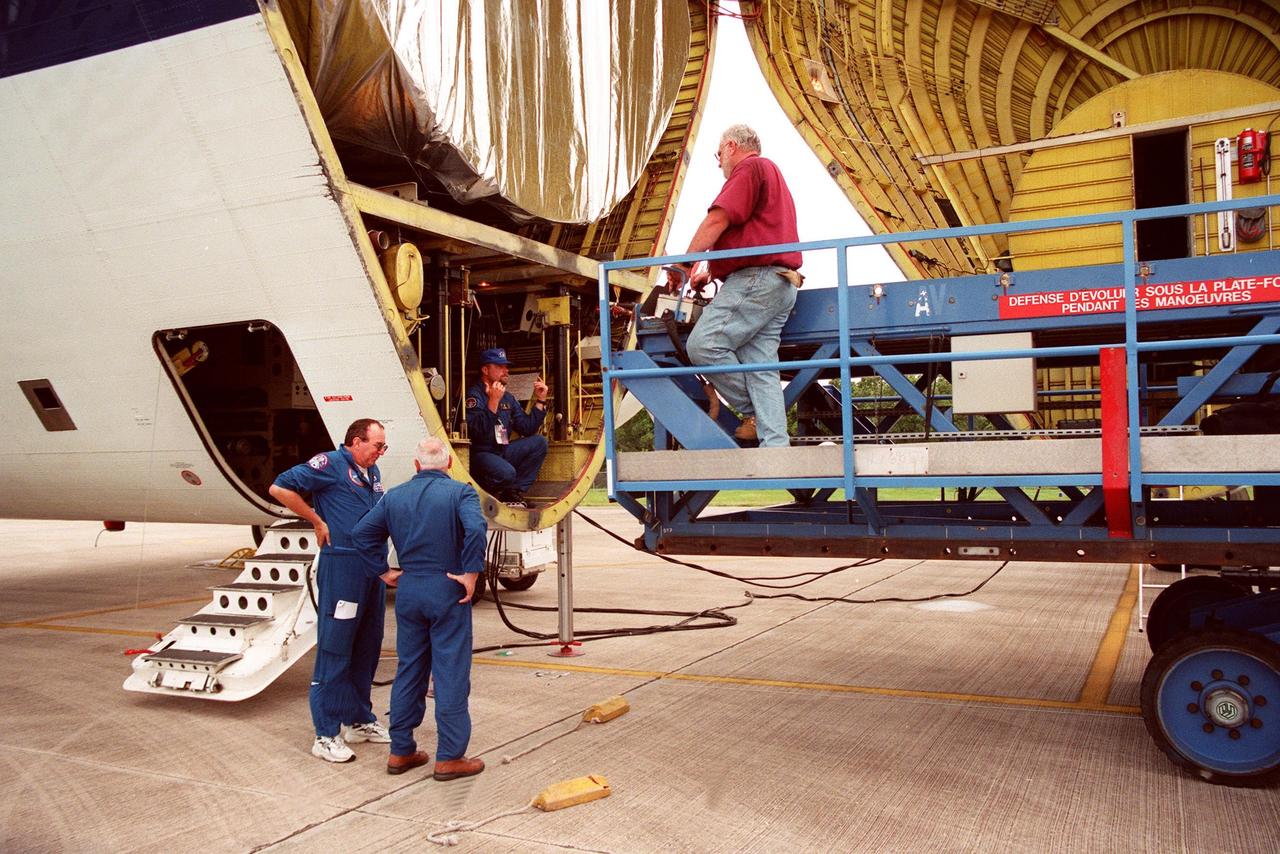 KENNEDY SPACE CENTER, Fla.  -  A transporter (right) is moved into place to remove a S0 (S Zero) truss segment (left) from inside the "Super Guppy" aircraft that brought it to KSC from Boeing in Huntington Beach, Calif.  The truss segment, which will become the backbone of the orbiting International Space Station (ISS), is a 44- by 15-foot structure weighing 30,800 pounds when fully outfitted and ready for launch.  It will be at the center of the ISS 10-truss, girderlike structure that will ultimately extend the length of a football field.  Eventually the S0 truss will be attached to the U.S. Lab, "Destiny," which is scheduled to be added to the ISS in April 2000.  Later, other trusses will be attached to the S0 on-orbit. During processing at KSC, the S0 truss will have installed the Canadian Mobile Transporter, power distribution system modules, a heat pipe radiator for cooling, computers, and a pair of rate gyroscopes.  Four Global Positioning System antennas are already installed.  The S0 truss is scheduled to be launched in the first quarter of 2001 on mission STS-108