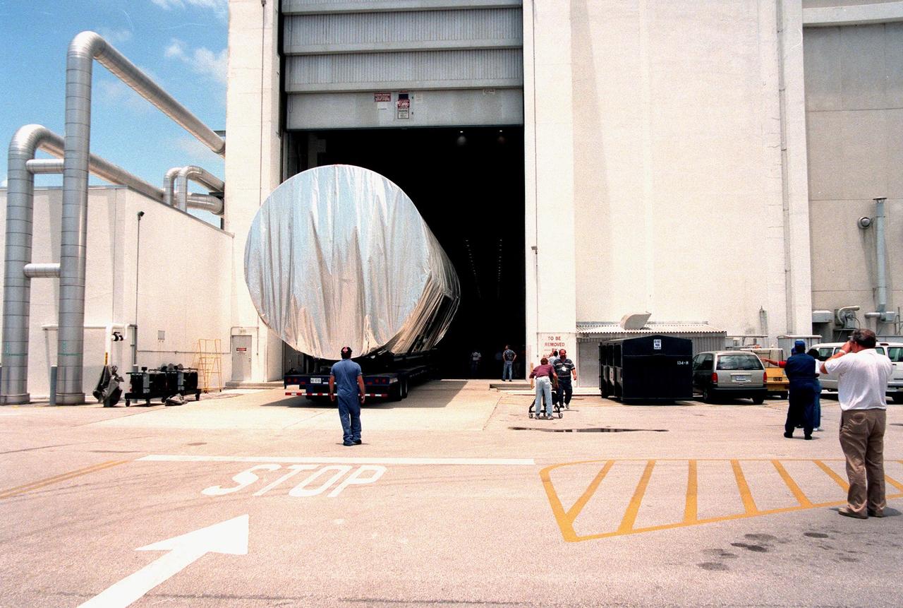 KENNEDY SPACE CENTER, FLA. -- The S0 truss segment is moved into the Operations and Checkout Bldg. (O&C) for processing. The truss arrived at the SLF aboard a "Super Guppy" aircraft from Boeing in Huntington, Calif. During processing in the O&C, the S0 truss will have installed the Canadian Mobile Transporter, power distribution system modules, a heat pipe radiator for cooling, computers, and a pair of rate gyroscopes. Four Global Positioning System antennas are already installed. A 44by 15-foot structure weighing 30,800 pounds when fully outfitted and ready for launch, the truss will be at the center of the ISS 10-truss, girderlike structure that will ultimately extend the length of a football field. Eventually the S0 truss will be attached to the U.S. Lab, "Destiny," which is scheduled to be added to the ISS in April 2000. Later, other trusses will be attached to the S0 on-orbit. The S0 truss is scheduled to be launched in the first quarter of 2001 on mission STS-108