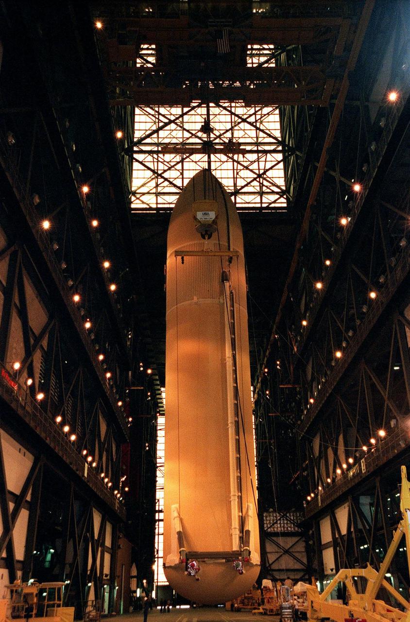 KENNEDY SPACE CENTER, FLA. -- An external tank is suspended in the transfer aisle of the Vehicle Assembly Building before being placed into its storage compartment. The largest and heaviest element of the Space Shuttle, an external tank contains the liquid hydrogen fuel and liquid oxygen oxidizer for the three Space Shuttle main engines (SSMEs) in the orbiter during liftoff and ascent. When the SSMEs are shut down, the external tank is jettisoned, breaking up as it enters the Earth's atmopshere and impacting in a remote ocean area. It is not recovered