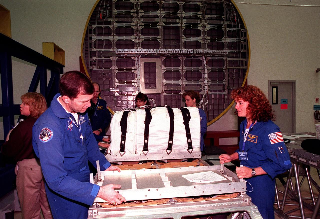 KENNEDY SPACE CENTER, FLA. -- In the SPACEHAB Facility, STS-96 crew members look over equipment during a payload Interface Verification Test (IVT) for their upcoming mission to the International Space Station. From left are Khristal Parker, with Boeing; Mission Specialist Dan Barry, Pilot Rick Husband, Mission Specialist Tamara Jernigan, and at the far right, Mission Specialist Julie Payette. An unidentified worker is in the background. Also at KSC for the IVT are Commander Kent Rominger and Mission Specialists Ellen Ochoa and Valery Tokarev of Russia. Mission STS-96 carries the SPACEHAB Logistics Double Module, which will have equipment to further outfit the International Space Station service module and equipment that can be off-loaded from the early U.S. assembly flights. It carries internal logistics and resupply cargo for station outfitting, plus an external Russian cargo crane to be mounted to the exterior of the Russian station segment and used to perform space walking maintenance activities. The double module stowage provides capacity of up to 10,000 lbs. with the ability to accommodate powered payloads, four external rooftop stowage locations, four double-rack locations (two powered), up to 61 bulkhead-mounted middeck locker locations, and floor storage for large unique items and Soft Stowage. STS-96 is targeted to launch May 20 about 9:32 a.m