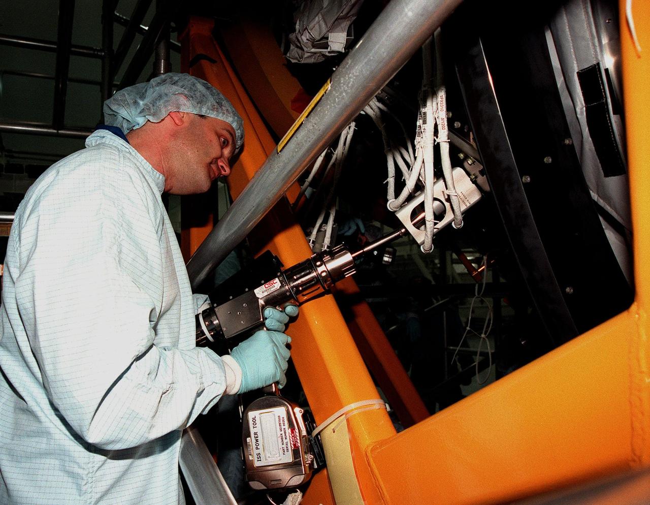 In the Space Station Processing Facility, STS-92 Mission Specialist Jeff Wisoff practices removing a wire harness from the Pressurized Mating Adapter-3, part of the payload on the STS-92 mission to the International Space Station (ISS). STS-92 is targeted for launch in December 1999. Other crew members visiting KSC are Commander Brian Duffy and Mission Specialists Koichi Wakata, Leroy Chiao, Michael Lopez-Alegria and Bill McArthur. STS-92 is the fourth U.S. flight for construction of the International Space Station. The payload also includes an integrated truss structure