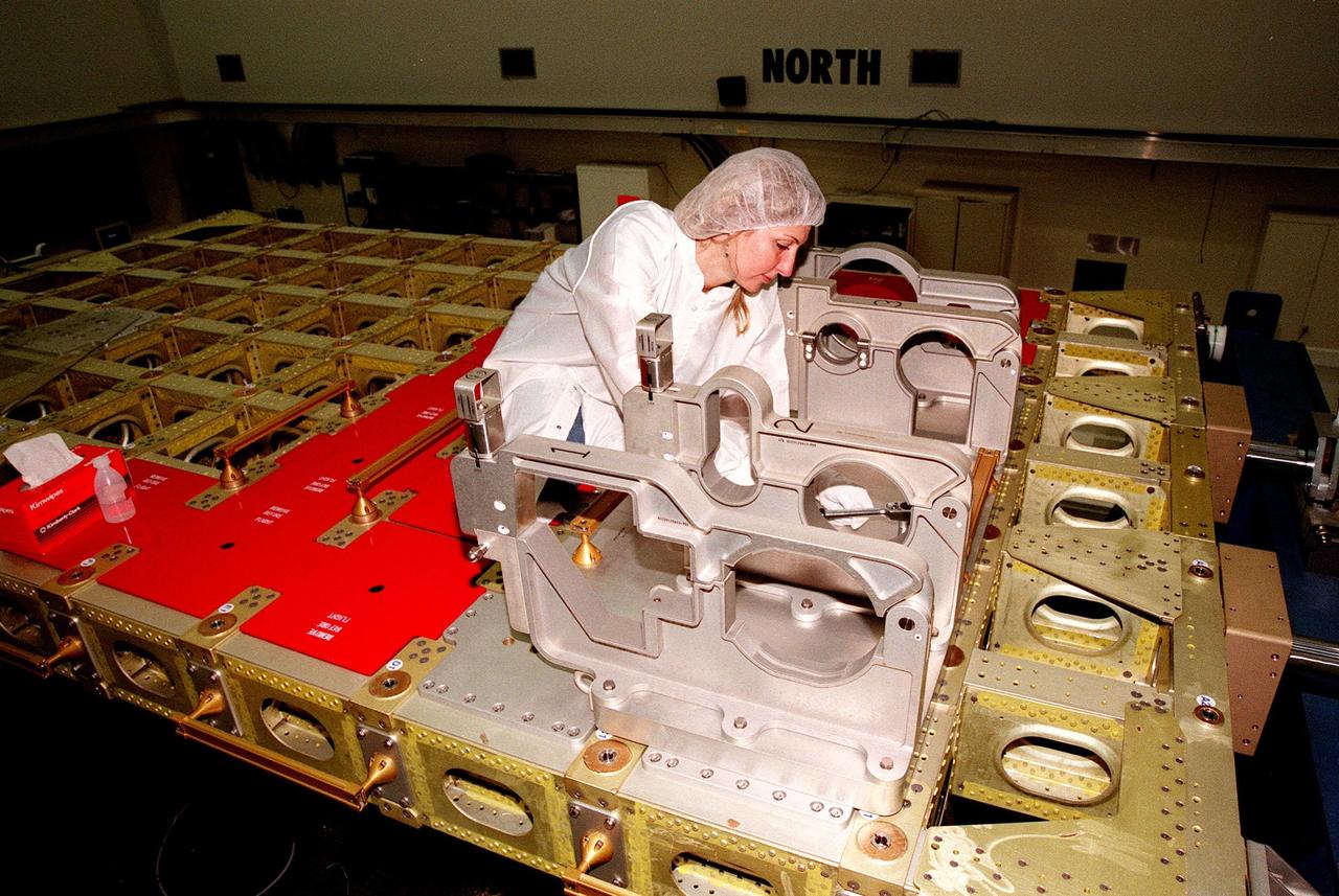 At Astrotech, Titusville, Fla., Lora Lawrence, with Johnson Space Center, makes a bonding check on the International Cargo Carrier that will be used during future International Space Station (ISS) assembly missions. The nonpressurized ICC fits inside the payload bay of the orbiter. The ICC will carry the SPACEHAB Oceaneering Space System Box (SHOSS), a logistics items carrier. SHOSS can hold a maximum of 400 pounds of equipment and will carry items to be used during STS-96 and future ISS assembly flights. Also aboard the ICC will be the ORU Transfer Device (OTD), a U.S.-built crane that will be stowed on Unity for use during future ISS assembly missions. The ICC will fly on mission STS-96, targeted for launch on May 20