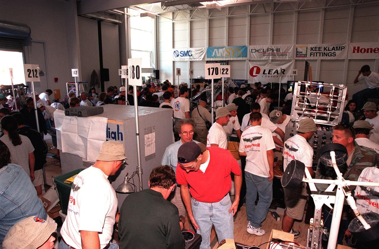 Student teams and sponsors, with their robots, fill the Center for Space Education at KSC as they look over the competition. Thirty schools from around the country have converged at KSC for the 1999 Southeastern Regional robotic competition March 4-6. The event pits the team-built gladiator robots against each other in an athletic-style competition. KSC is hosting the event being sponsored by the nonprofit organization For Inspiration and Recognition of Science and Technology, known as FIRST. The FIRST robotics competition is designed to provide students with a hands-on, inside look at engineering and other professional careers