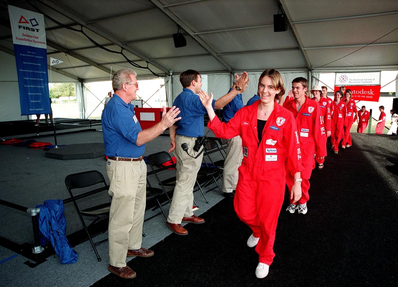 At the start of the award ceremony at the 1999 FIRST Southeastern Regional robotic competition held at KSC, judges, including Deputy Director for Launch and Payload Processing Loren Shriver (left), give "high fives" to a winning team from Minnesota as they enter. FIRST is a nonprofit organization, For Inspiration and Recognition of Science and Technology, that sponsors the event pitting gladiator robots against each other in an athletic-style competition. The FIRST robotics competition is designed to provide students with a hands-on, inside look at engineering and other professional careers, pairing high school students with engineer mentors and corporations. The regional event comprised 27 teams. Along with the championship award, which went to high school teams in Miami and San German, Puerto Rico, 15 other awards were presented