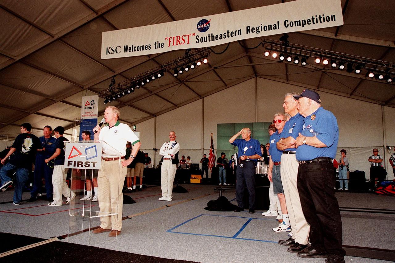At the award ceremony for the 1999 FIRST Southeastern Regional robotic competition held at KSC, Center Director Roy Bridges addresses the teams, encouraging them to continue their interest in engineering. Directly behind him (left) are Woody Flowers, national advisor to FIRST, and (right) former KSC Director of Shuttle Processing Robert Sieck, who served as one of the judges. At the far left, students gather around astronaut David Brown, who was present during the two days of matches. At right are other judges, including Deputy Director for Launch and Payload Processing Loren Shriver (third from right). FIRST is a nonprofit organization, For Inspiration and Recognition of Science and Technology, that sponsors the event pitting gladiator robots against each other in an athletic-style competition. The FIRST robotics competition is designed to provide students with a hands-on, inside look at engineering and other professional careers, pairing high school students with engineer mentors and corporations. The regional event comprised 27 teams. Along with the championship award, which went to high school teams in Miami and San German, Puerto Rico, 15 other awards were presented