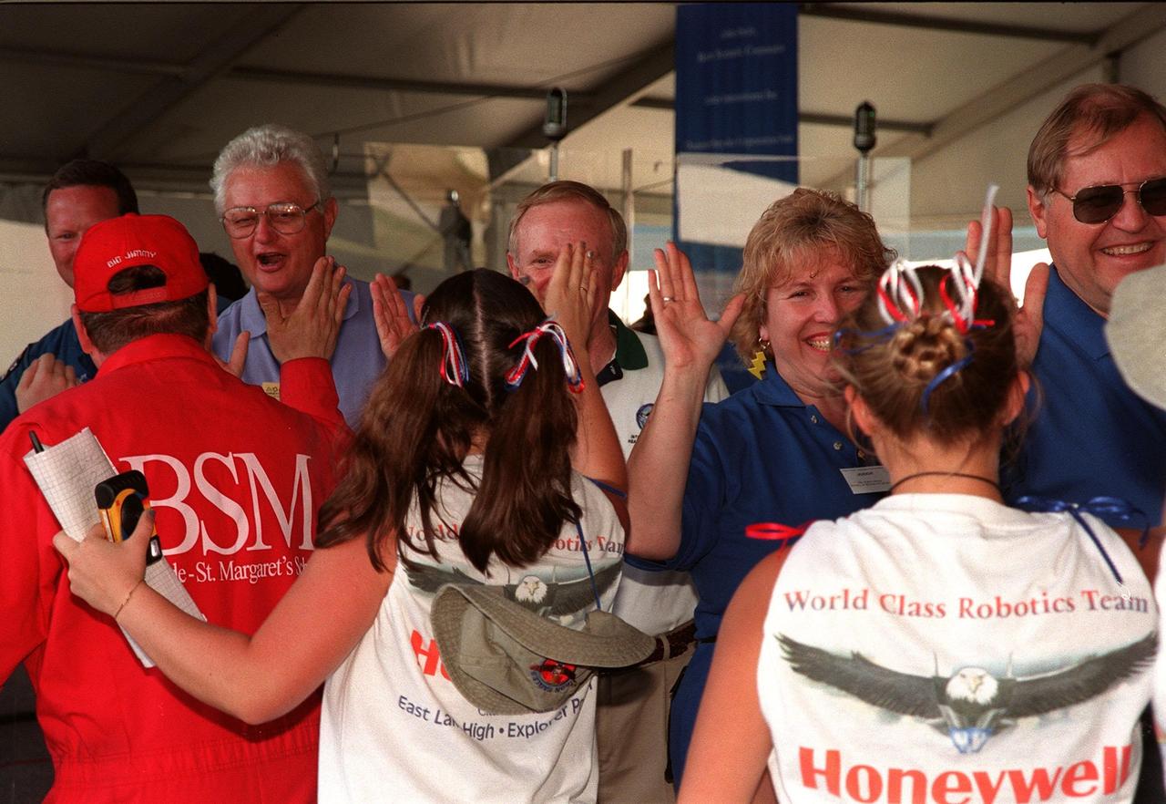 At the award ceremony for the 1999 FIRST Southeastern Regional robotic competition held at KSC, one of the winning teams, from Ocoee, Fla., is greeted by (left to right) astronaut David Brown, Deputy Director for Launch and Payload Processing Loren Shriver, Center Director Roy Bridges, and two unidentified judges. FIRST is a nonprofit organization, For Inspiration and Recognition of Science and Technology, that sponsors the event pitting gladiator robots against each other in an athletic-style competition. The FIRST robotics competition is designed to provide students with a hands-on, inside look at engineering and other professional careers, pairing high school students with engineer mentors and corporations. The regional event comprised 27 teams. Along with the championship award, which went to high school teams from Miami and San German, Puerto Rico, 15 other awards were presented