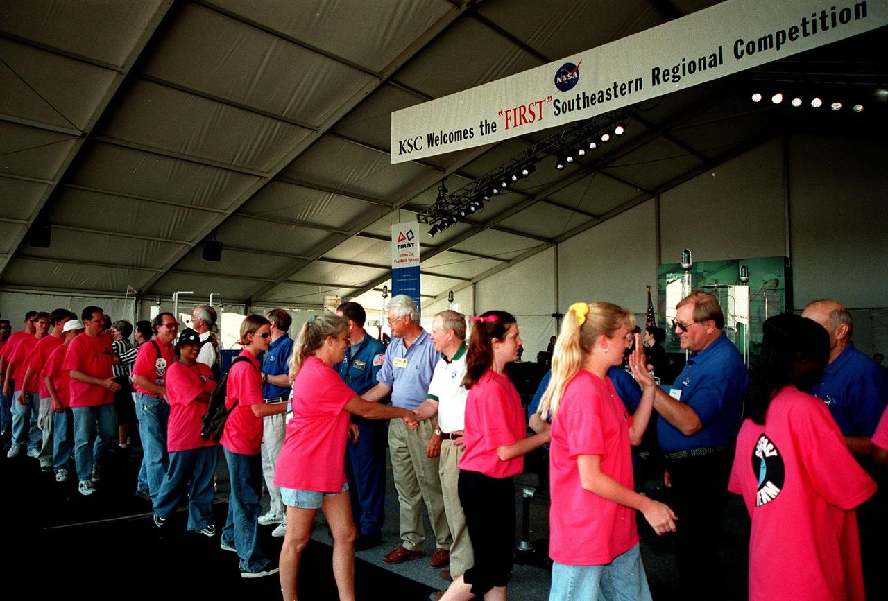 At the award ceremony for the 1999 FIRST Southeastern Regional robotic competition held at KSC, the Space Coast FIRST Team walks past the greeting line. In the middle, shaking hands with the team, are KSC's Director of Engineering Development Sterling Walker (left) and Center Director Roy Bridges (right). The Space Coast Team included Rockledge, Cocoa Beach and Merritt Island High Schools. FIRST is a nonprofit organization, For Inspiration and Recognition of Science and Technology, that sponsors the event pitting gladiator robots against each other in an athletic-style competition. The FIRST robotics competition is designed to provide students with a hands-on, inside look at engineering and other professional careers, pairing high school students with engineer mentors and corporations. The regional event comprised 27 teams. Along with the championship award, which went to high school teams from Miami and San German, Puerto Rico, 15 other awards were presented