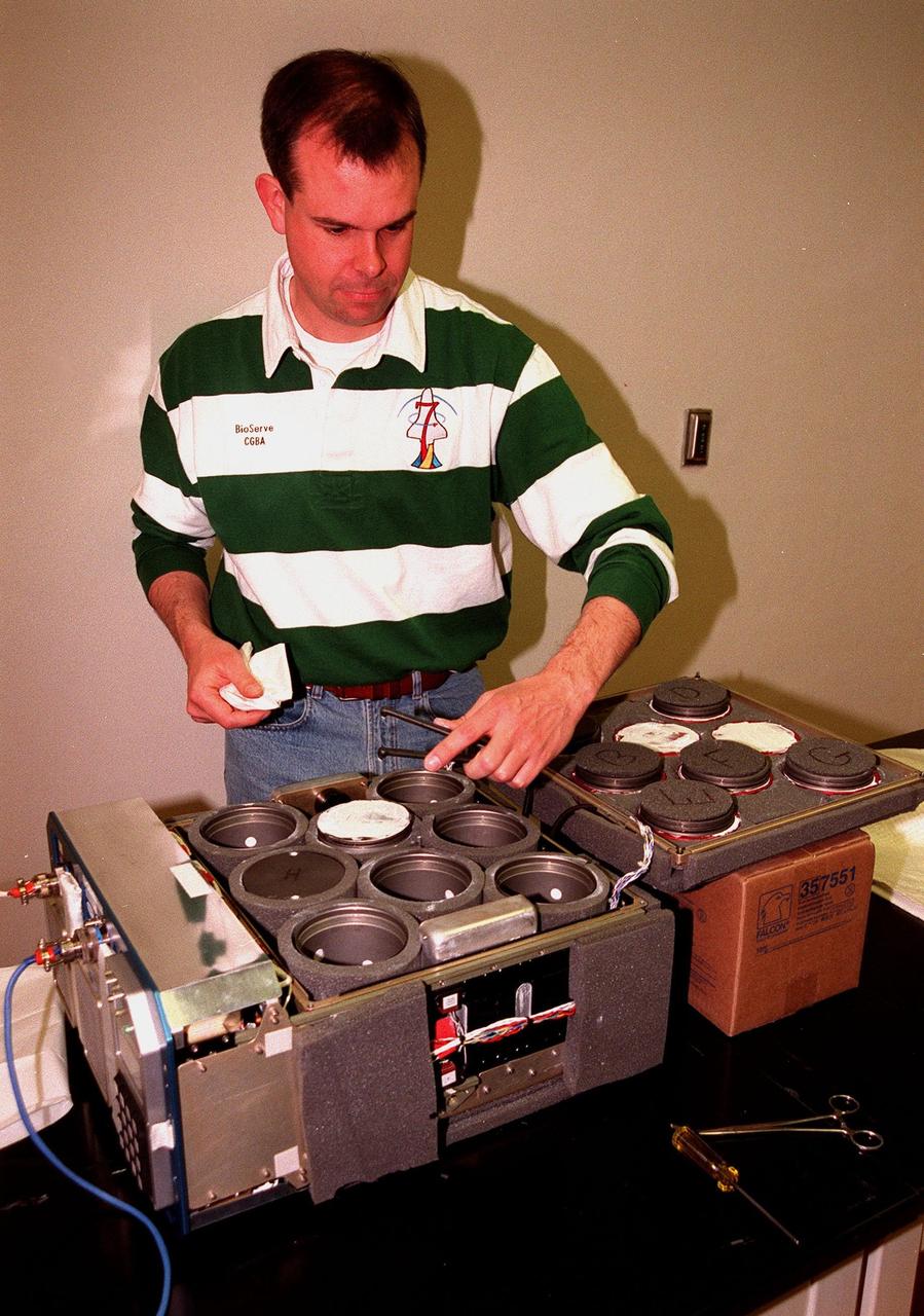 In the KSC Life Sciences Building, Hangar L, Cape Canaveral Air Station, Mark Rupert, with BioServe Space Technologies, checks the canisters, or incubators, that will hold an experiment to fly on mission STS-93. The incubators will hold a mix of fruit fly embryos and larvae to examine the effects of microgravity and space flight on the development of neural connections between specific motor neurons and their targets in muscle fibers. The incubators are part of a Commercial Generic Bioprocessing Apparatus (CGBA), which can start bioprocessing reactions by mixing or heating a sample and can also initiate multiple-step, sequential reactions in a technique called phased processing. The primary payload of mission STS-93 is the Chandra X-ray Observatory, which will allow scientists from around the world to see previously invisible black holes and high-temperature gas clouds, giving the observatory the potential to rewrite the books on the structure and evolution of our universe. The target launch date for STS-93 is July 9, aboard Space Shuttle Columbia, from Launch Pad 39B