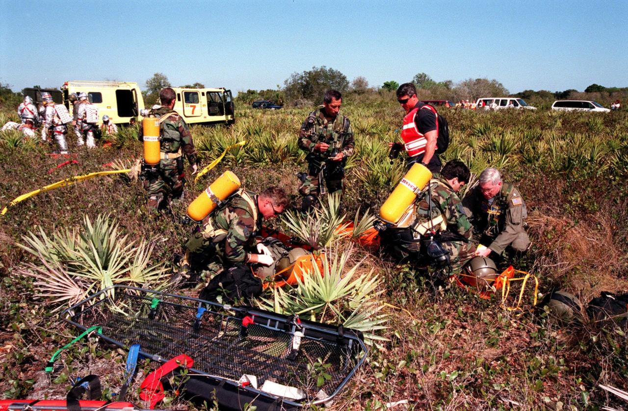 KENNEDY SPACE CENTER, FLA. -- In the simulated rescue mission, the KSC response team takes part in the unlikely scenario of a Shuttle mishap at the Shuttle Landing Facility. The Mode 7 simulation of an astronaut rescue exercised all aspects of command and control, search and rescue, and medical procedures required for a successful rescue. The remote location of the mock-up prevents a totally land-based crew rescue, and calls on a NASA UH-1 helicopter to locate the site and four Air Force HH-60 helicopters to drop emergency equipment and fire/rescue workers to prepare the "crew" for preliminary triage. The helicopters later are used to remove the crew five astronaut candidates, one representative from the Vehicle Integration Test office, and one fire/rescue worker. The exercise concluded with airlifted "patients" arriving safely in the emergency rooms of participating area hospitals.