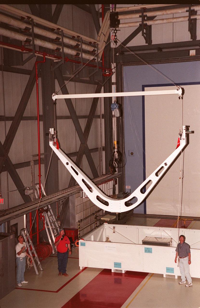 KENNEDY SPACE CENTER, FLA. -- In the Orbiter Processing Facility (OPF) Bay 1, workers lift the Keel Yoke Device (KYD) that will be fitted inside the payload bay of orbiter Discovery. The KYD will support the International Cargo Carrier (ICC) to be installed in the orbiter for mission STS-96. The ICC will carry unpressurized cargo such as the external Russian cargo crane known as STRELA, the SPACEHAB Oceaneering Space System Box (SHOSS), which is a logistics items carrier, and an ORU Transfer Device (OTD), a U.S.-built crane that will be stowed on the station for use during future ISS assembly missions. The primary payload of STS-96 is the SPACEHAB Double Module, an element of the International Space Station. STS-96 is targeted for launch on May 20 at 9:32 a.m. from Launch Pad 39B