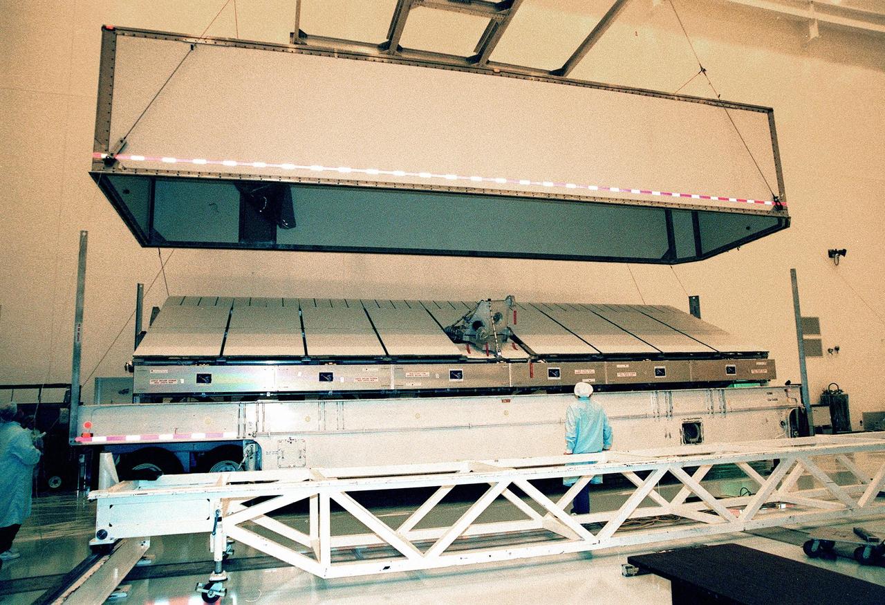 Inside the Multi-Payload Processing Facility, the lid covering the Shuttle Radar Topography Mission (SRTM) is lifted. The primary payload on mission STS-99, the SRTM consists of a specially modified radar system that will fly onboard the Space Shuttle during the 11-day mission scheduled for September 1999. This radar system will gather data that will result in the most accurate and complete topographic map of the Earth's surface that has ever been assembled. SRTM is an international project spearheaded by the National Imagery and Mapping Agency and NASA, with participation of the German Aerospace Center DLR. Its objective is to obtain the most complete high-resolution digital topographic database of the Earth