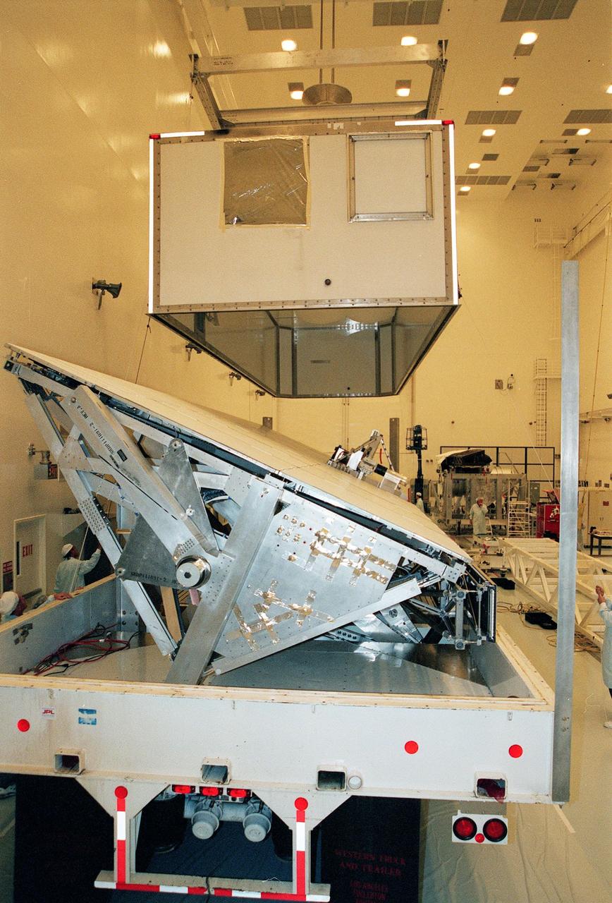 Inside the Multi-Payload Processing Facility, the lid covering the Shuttle Radar Topography Mission (SRTM) is lifted from the crate. The primary payload on mission STS-99, the SRTM consists of a specially modified radar system that will fly onboard the Space Shuttle during the 11-day mission scheduled for September 1999. This radar system will gather data that will result in the most accurate and complete topographic map of the Earth's surface that has ever been assembled. SRTM is an international project spearheaded by the National Imagery and Mapping Agency and NASA, with participation of the German Aerospace Center DLR. Its objective is to obtain the most complete high-resolution digital topographic database of the Earth