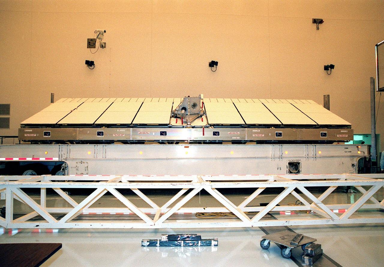 Inside the Multi-Payload Processing Facility, the Shuttle Radar Topography Mission (SRTM) is revealed after the lid of its container was removed. The primary payload on mission STS-99, the SRTM consists of a specially modified radar system that will fly onboard the Space Shuttle during the 11-day mission scheduled for September 1999. This radar system will gather data that will result in the most accurate and complete topographic map of the Earth's surface that has ever been assembled. SRTM is an international project spearheaded by the National Imagery and Mapping Agency and NASA, with participation of the German Aerospace Center DLR. Its objective is to obtain the most complete high-resolution digital topographic database of the Earth