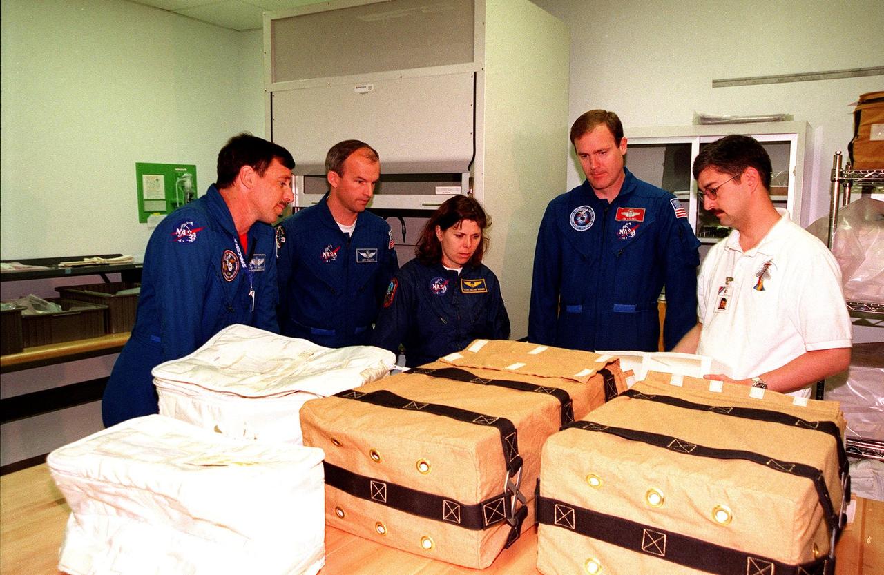KENNEDY SPACE CENTER, FLA. -- STS-101 crew members take part in a bench review at the SPACEHAB Facility as part of familiarization activities for their upcoming mission. From left are Pilot Scott J. "Doc" Horowitz (Ph.D.), Mission Specialists Jeffrey N. Williams and Mary Ellen Weber (Ph.D.), and Commander James Donald Halsell Jr., plus Sean Hicks, with Boeing in Huntsville, Ala. Other crew members are Mission Specialists Edward Tsang Lu (Ph.D.), and Yuri Ivanovich Malenchenko and Boris Morukov, who represent the Russian Space Agency. Mission STS-101 is the third flight in construction of the International Space Station. The 11-day mission is targeted for launch on December 2, 1999, at Launch Pad 39A