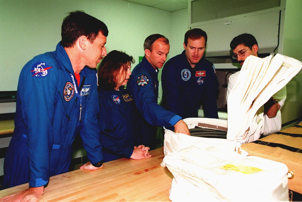 KENNEDY SPACE CENTER, FLA. -- At the SPACEHAB Facility, members of the STS-101 crew look over equipment during familiarization activities. From left are Pilot Scott J. "Doc" Horowitz (Ph.D.), Mission Specialists Mary Ellen Weber (Ph.D.) and Jeffrey N. Williams, and Commander James Donald Halsell Jr., plus Sean Hicks, with Boeing in Huntsville, Ala. Other crew members are Mission Specialists Edward Tsang Lu (Ph.D.), and Yuri Ivanovich Malenchenko and Boris Morukov, who represent the Russian Space Agency. Mission STS-101 is the third flight in construction of the International Space Station. The 11-day mission is targeted for launch on December 2, 1999, at Launch Pad 39A