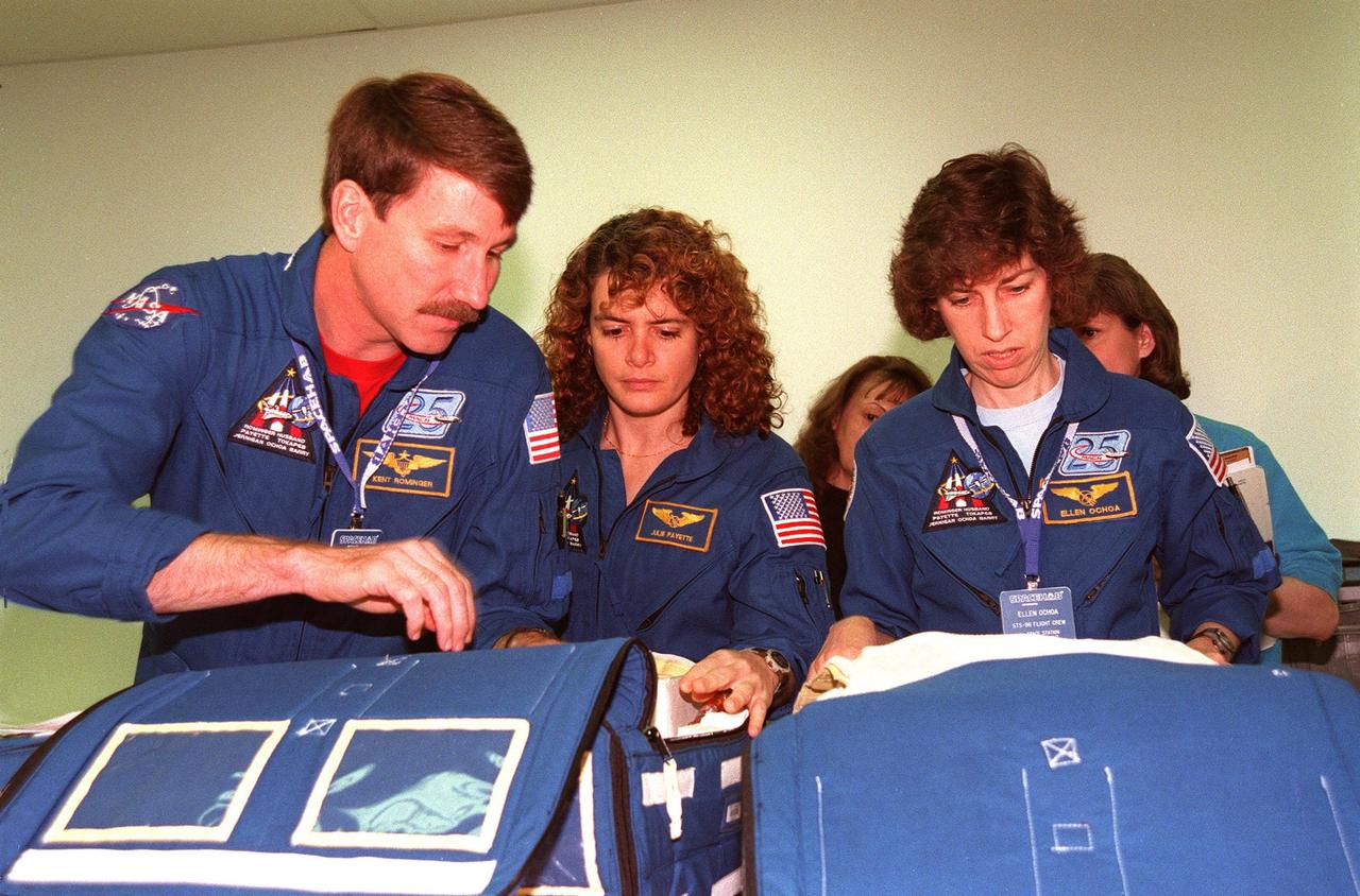 KENNEDY SPACE CENTER, FLA. -- (From left) STS-96 Commander Kent V. Rominger and Mission Specialists Julie Payette and Ellen Ochoa look over equipment at the SPACEHAB Facility. Members of the STS-96 crew are taking part in a bench review at SPACEHAB as part of familiarization activities for their upcoming mission. The crew also includes Pilot Rick Husband and Mission Specialists Tamara E. Jernigan, Daniel Barry, and Valery Ivanovich Tokarev. Payette is with the Canadian Space Agency and Tokarev with the Russian Space Agency. Mission STS-96 is the second flight in construction of the International Space Station and will include the SPACEHAB. The 10-day mission is targeted for launch on May 24, 1999, at Launch Pad 39B