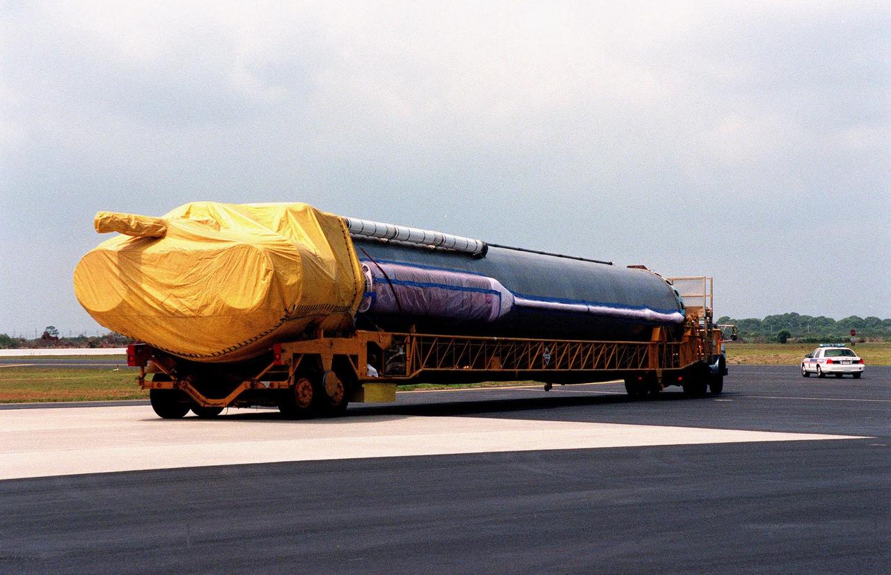 An Atlas IIA rocket is transported from Cape Canaveral Air Station after its arrival aboard a U.S. Air Force C-5c. The rocket is scheduled to launch the NASA GOES-L satellite from Launch Pad 36A on May 15. Once in orbit, the satellite will become GOES-11, joining GOES-8, GOES-9 and GOES-10 in space. The fourth of a new advanced series of geostationary weather satellites for the National Oceanic and Atmospheric Administration (NOAA), GOES-L is a three-axis inertially stabilized spacecraft that will provide pictures and perform atmospheric sounding at the same time. Once launched, the satellite will undergo checkout and then provide backup capabilities for the existing, aging operational satellites