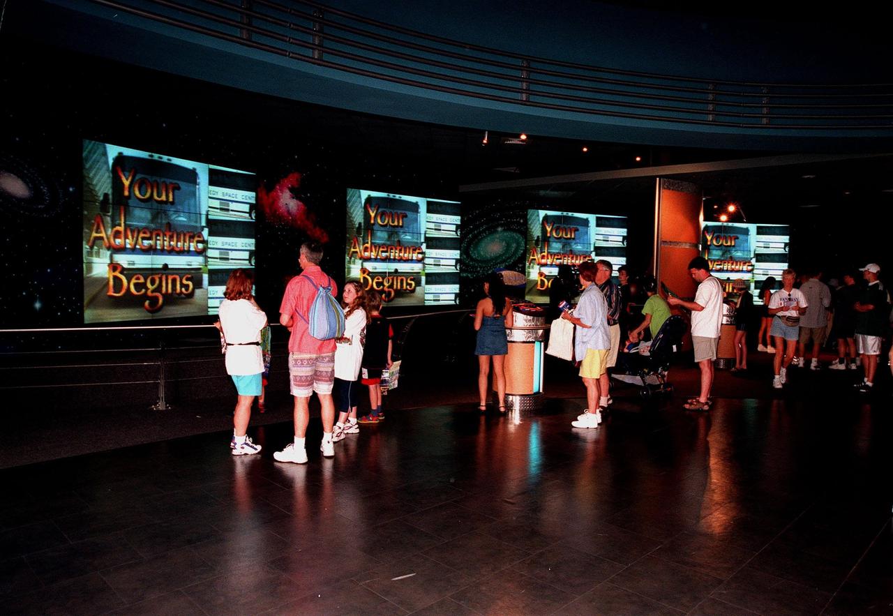 KENNEDY SPACE CENTER, FLA. -- Part of the $13 million expansion to KSC's Visitor Complex, the new information center welcomes visitors to the Gateway to the Universe. The five large video walls provide an orientation video, with an introduction to the range of activities and exhibits, and honor the center's namesake, President John F. Kennedy. Other additions include a walk-through Robot Scouts exhibit, a wildlife exhibit, and the film Quest for Life in a new 300-seat theater, plus an International Space Station-themed ticket plaza, featuring a structure of overhanging solar panels and astronauts performing assembly tasks. The KSC Visitor Complex was inaugurated three decades ago and is now one of the top five tourist attractions in Florida. It is located on S.R. 407, east of I-95, within the Merritt Island National Wildlife Refuge