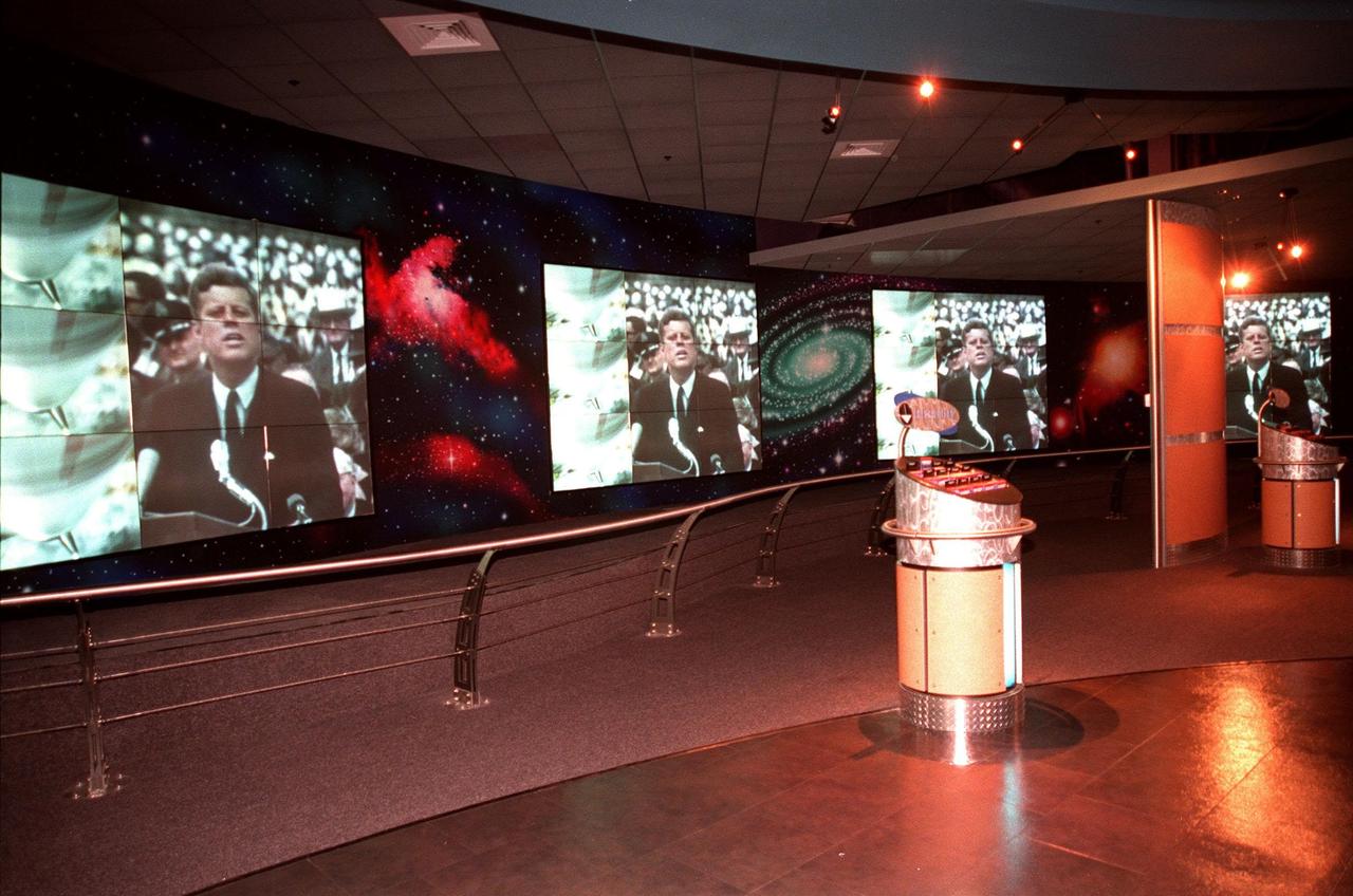 KENNEDY SPACE CENTER, FLA. -- Part of the $13 million expansion to KSC's Visitor Complex, the new information center welcomes visitors to the Gateway to the Universe. The five large video walls provide an orientation video, with an introduction to the range of activities and exhibits, and honor the center's namesake, President John F. Kennedy. Other new additions include a walk-through Robot Scouts exhibit, a wildlife exhibit, and the film Quest for Life in a new 300-seat theater, and an International Space Station-themed ticket plaza, featuring a structure of overhanging solar panels and astronauts performing assembly tasks. The KSC Visitor Complex was inaugurated three decades ago and is now one of the top five tourist attractions in Florida. It is located on S.R. 407, east of I-95, within the Merritt Island National Wildlife Refuge