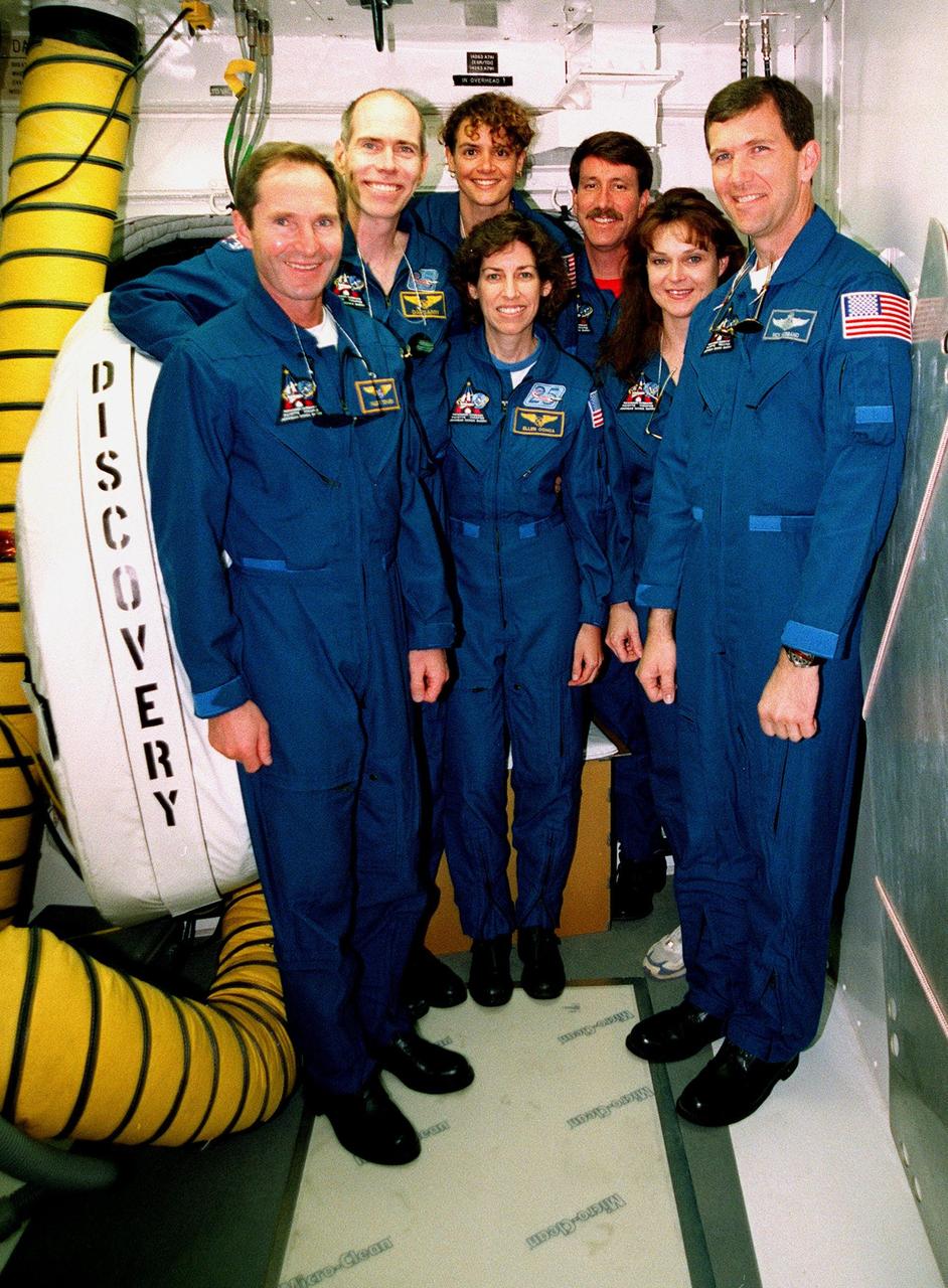 The STS-96 crew take a photo break during Terminal Countdown Demonstration Test (TCDT) activities at Launch Pad 39B. From left, they are Mission Specialists Valery Ivanovich Tokarev, Daniel Barry (M.D., Ph.D.), Julie Payette, Ellen Ochoa (Ph.D.), Commander Kent V. Rominger, Mission Specialist Tamara E. Jernigan (Ph.D.) and Pilot Rick Douglas Husband. Payette is with the Canadian Space Agency and Tokarev with the Russian Space Agency. The TCDT provides simulated countdown exercises, emergency egress training and opportunities to inspect the mission payloads in the orbiter's payload bay. STS-96, which is scheduled for liftoff on May 20 at 9:32 a.m., is a logistics and resupply mission for the International Space Station, carrying such payloads as a Russian crane, the Strela; a U.S.-built crane; the Spacehab Oceaneering Space System Box (SHOSS), a logistics items carrier; and STARSHINE, a student-led experiment