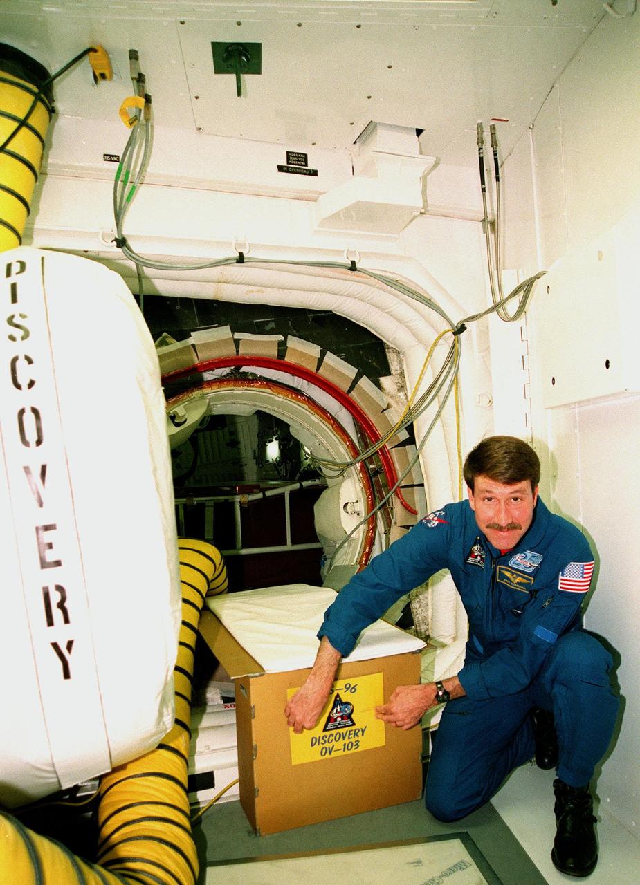 At Launch Pad 39B, STS-96 Commander Kent V. Rominger places a crew patch on the entry into Discovery. The STS-96 crew are taking part in Terminal Countdown Demonstration Test activities which provide simulated countdown exercises, emergency egress training and opportunities to inspect the mission payloads in the orbiter's payload bay. The other crew members are Pilot Rick Douglas Husband and Mission Specialists Ellen Ochoa (Ph.D.), Tamara E. Jernigan (Ph.D.), Daniel Barry (M.D., Ph.D.), Julie Payette, with the Canadian Space Agency, and Valery Ivanovich Tokarev, with the Russian Space Agency. STS-96, which is scheduled for liftoff on May 20 at 9:32 a.m., is a logistics and resupply mission for the International Space Station, carrying such payloads as a Russian crane, the Strela; a U.S.-built crane; the Spacehab Oceaneering Space System Box (SHOSS), a logistics items carrier; and STARSHINE, a student-led experiment
