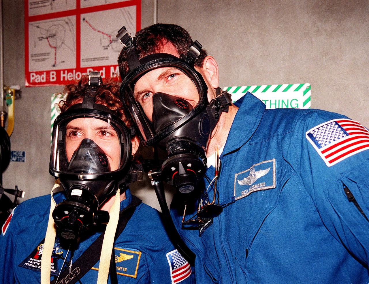 At Launch Pad 39B, STS-96 Mission Specialist Julie Payette, with the Canadian Space Agency, and Pilot Rick Douglas Husband practice putting on oxygen gas masks as part of Terminal Countdown Demonstration Test (TCDT) activities. The TCDT provides the crew with emergency egress traiing, simulated countdown exercises and opportunities to inspect the mission payloads in the orbiter's payload bay. Other crew members taking part in the TCDT are Commander Kent V. Rominger and Mission Specialists Tamara E. Jernigan (Ph.D.), Daniel Barry (M.D., Ph.D.), Ellen Ochoa (Ph.D.) and Valery Ivanovich Tokarev, with the Russian Space Agency. Scheduled for liftoff on May 20 at 9:32 a.m., STS-96 is a logistics and resupply mission for the International Space Station, carrying such payloads as a Russian crane, the Strela; a U.S.-built crane; the Spacehab Oceaneering Space System Box (SHOSS), a logistics items carrier; and STARSHINE, a student-led experiment