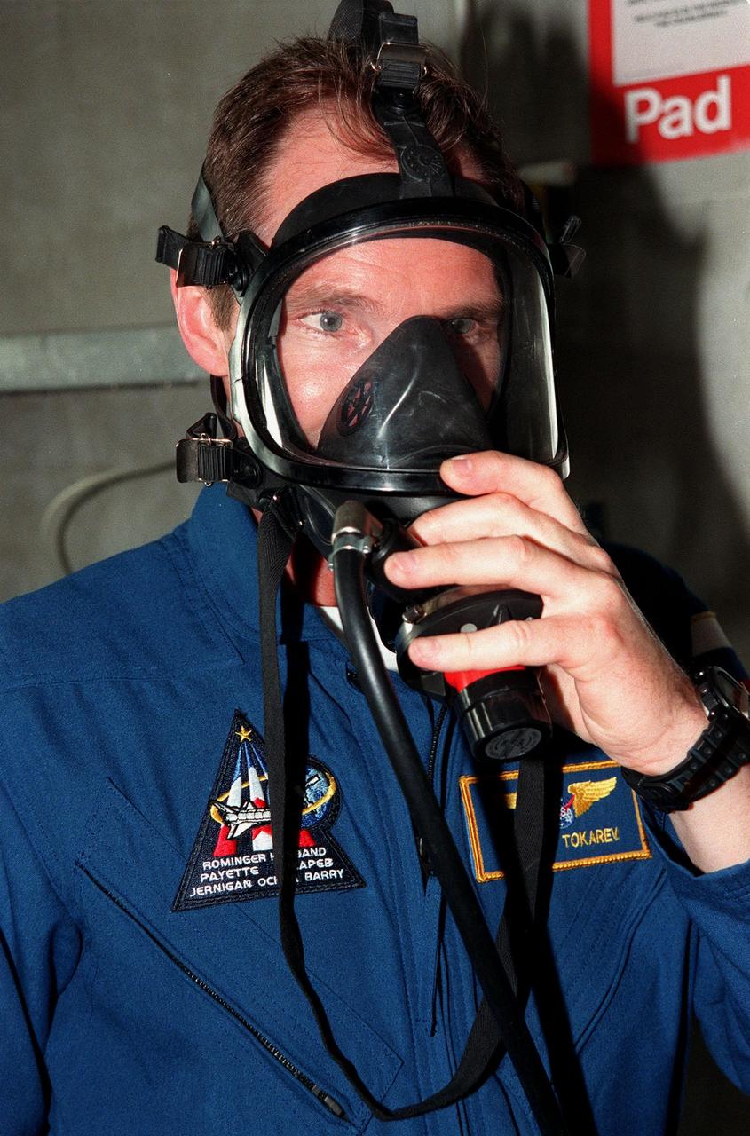 STS-96 Mission Specialist Valery Ivanovich Tokarev, with the Russian Space Agency, tries on an oxygen gas mask during Terminal Countdown Demonstration Test (TCDT) activities at Launch Pad 39B. The TCDT provides the crew with simulated countdown exercises, emergency egress training and opportunities to inspect the mission payloads in the orbiter's payload bay. Other crew members taking part in the TCDT are Commander Kent V. Rominger, Pilot Rick Douglas Husband, and Mission Specialists Tamara E. Jernigan (Ph.D.), Daniel Barry (M.D., Ph.D.), Ellen Ochoa (Ph.D.) and Julie Payette, with the Canadian Space Agency. Scheduled for liftoff on May 20 at 9:32 a.m., STS-96 is a logistics and resupply mission for the International Space Station, carrying such payloads as a Russian crane, the Strela; a U.S.-built crane; the Spacehab Oceaneering Space System Box (SHOSS), a logistics items carrier; and STARSHINE, a student-led experiment