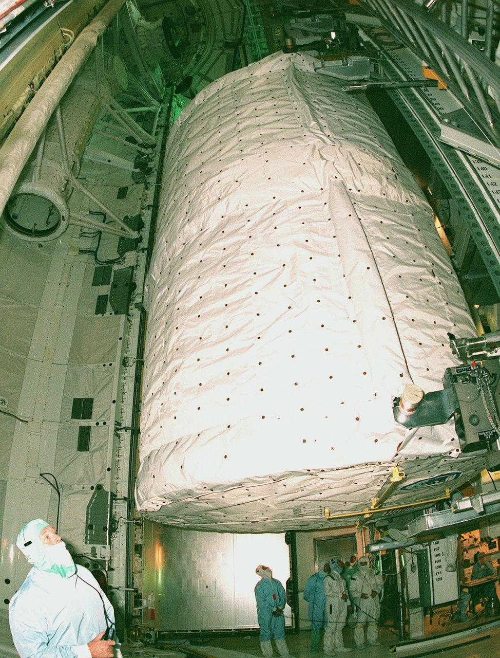 KENNEDY SPACE CENTER, FLA. -- In the payload changeout room at Launch Pad 39B, technicians move the SPACEHAB Double module from the payload canister before placing it in Space Shuttle Discovery's payload bay for mission STS-96. The second flight supporting construction of the International Space Station, STS-96 is a logistics and resupply mission, carrying more than 5,000 pounds of supplies, a Russian-built crane and a U.S.-built crane, plus experiments such as STARSHINE, which was developed by and for students. Comprising the crew are Commander Kent V. Rominger, Pilot Rick Douglas Husband, and Mission Specialists Ellen Ochoa (Ph.D.), Tamara E. Jernigan (Ph.D.), Daniel Barry (M.D., Ph.D.), Julie Payette, with the Canadian Space Agency, and Valery Ivanovich Tokarev, with the Russian Space Agency. Liftoff is scheduled for May 20 at 9:32 a.m. EDT