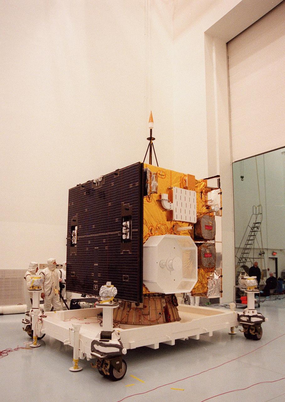 The GOES-L weather satellite sits on a workstand at Astrotech, Titusville, Fla., ready to be encapsulated for its transfer to Launch Pad 36A, Cape Canaveral Air Station. On the left side is the folded, two-panel solar array; on the adjoining side is a white box, which is the UHF antenna. Above the box is the S-band transmit antenna and receive antenna. Between them protrudes a search and rescue antenna. At right are the sounder (top) and imager (bottom). The mounted equipment on top of the unit is a telemetry and command antenna. The GOES is scheduled for launch aboard a Lockheed Martin Atlas II rocket later in May. The fourth of a new advanced series of geostationary weather satellites for the National Oceanic and Atmospheric Administration (NOAA), GOES-L is a three-axis inertially stabilized spacecraft that will provide pictures and perform atmospheric sounding at the same time. After it is launched, the satellite will undergo checkout and then provide backup capabilities for the existing, aging operational satellites. Once in orbit, the satellite will become GOES-11, joining GOES-8, GOES-9 and GOES-10 in space