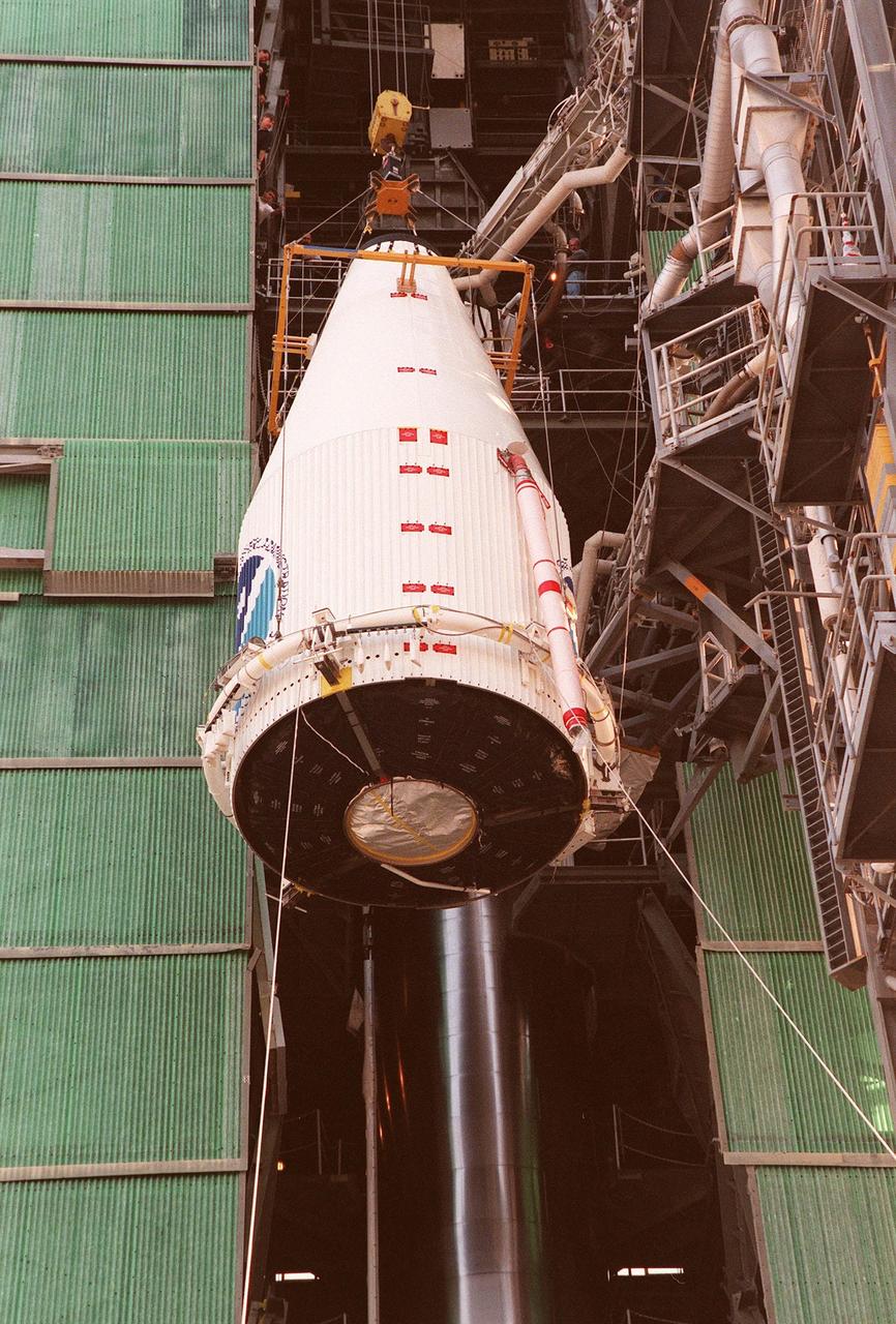 At Launch Pad 36A, Cape Canaveral Air Station, an encapsulated GOES-L weather satellite is lifted up the gantry for mating to a Lockheed Martin Atlas II rocket. The fourth of a new advanced series of geostationary weather satellites for the National Oceanic and Atmospheric Administration (NOAA), GOES-L is a three-axis inertially stabilized spacecraft that will provide pictures and perform atmospheric sounding at the same time. After it is launched, the satellite will undergo checkout and then provide backup capabilities for the existing, aging operational satellites. Once in orbit, the satellite will become GOES-11, joining GOES-8, GOES-9 and GOES-10 in space. The GOES is scheduled for launch later this month