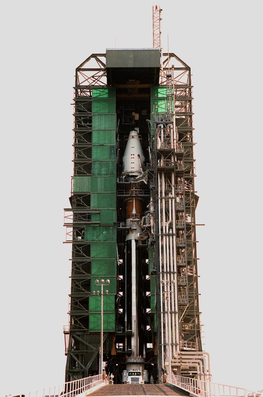 At Launch Pad 36A, Cape Canaveral Air Station, an encapsulated GOES-L weather satellite (top center) is prepared for mating to the a Lockheed Martin Atlas II rocket below it. The fourth of a new advanced series of geostationary weather satellites for the National Oceanic and Atmospheric Administration (NOAA), GOES-L is a three-axis inertially stabilized spacecraft that will provide pictures and perform atmospheric sounding at the same time. After it is launched, the satellite will undergo checkout and then provide backup capabilities for the existing, aging operational satellites. Once in orbit, the satellite will become GOES-11, joining GOES-8, GOES-9 and GOES-10 in space. The GOES is scheduled for launch later this month