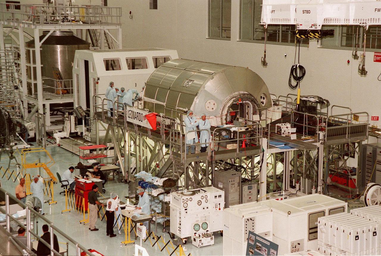 KENNEDY SPACE CENTER, FLA. -- Workers in the Space Station Processing Facility work on Leonardo, the Multipurpose Logistics Module (MPLM) built by the Agenzia Spaziale Italiana (ASI). The MPLM, a reusable logistics carrier, will be the primary delivery system used to resupply and return International Space Station cargo requiring a pressurized environment. Leonardo is the first of three MPLM carriers for the International Space Station. It is scheduled to be launched on Space Shuttle Mission STS-102, targeted for June 2000. Leonardo shares space in the SSPF with the Shuttle Radar Topography Mission (SRTM), targeted for launch in September 1999, and Destiny, the U.S. Lab module, targeted for mission STS-98 in late April 2000