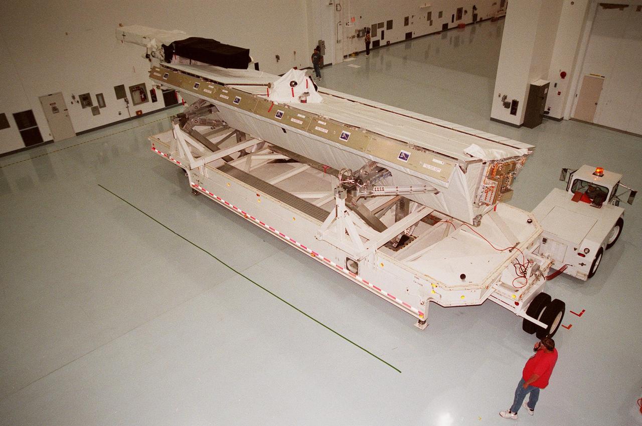 Inside the Space Station Processing Facility, the Shuttle Radar Topography Mission (SRTM) is maneuvered into place to prepare it for launch targeted for September 1999. The primary payload on mission STS-99, the SRTM consists of a specially modified radar system that will fly onboard the Space Shuttle during the 11-day mission. This radar system will gather data that will result in the most accurate and complete topographic map of the Earth's surface that has ever been assembled. SRTM is an international project spearheaded by the National Imagery and Mapping Agency and NASA, with participation of the German Aerospace Center DLR. Its objective is to obtain the most complete high-resolution digital topographic database of the Earth