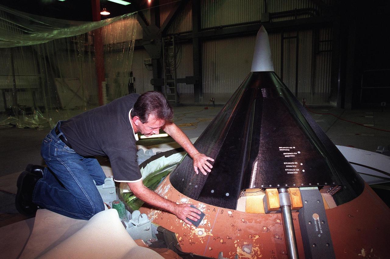 KENNEDY SPACE CENTER, FLA. -- In the Vehicle Assembly Building (VAB), United Space Alliance technician Robert Williams sands the repaired areas near the top of Space Shuttle Discovery's external tank. Repairs were required for damage caused by hail during recent storms. Because access to all of the damaged areas was not possible at the pad, the Shuttle was rolled back from Pad 39B to the VAB. The work is expected to take two to three days, allowing Discovery to roll back to the pad late this week for launch of mission STS-96, the 94th launch in the Space Shuttle Program. Liftoff will occur no earlier than May 27. STS-96 is a logistics and resupply mission for the International Space Station, carrying such payloads as a Russian crane, the Strela; a U.S.-built crane; the Spacehab Oceaneering Space System Box (SHOSS), a logistics items carrier; and STARSHINE, a student-shared experiment