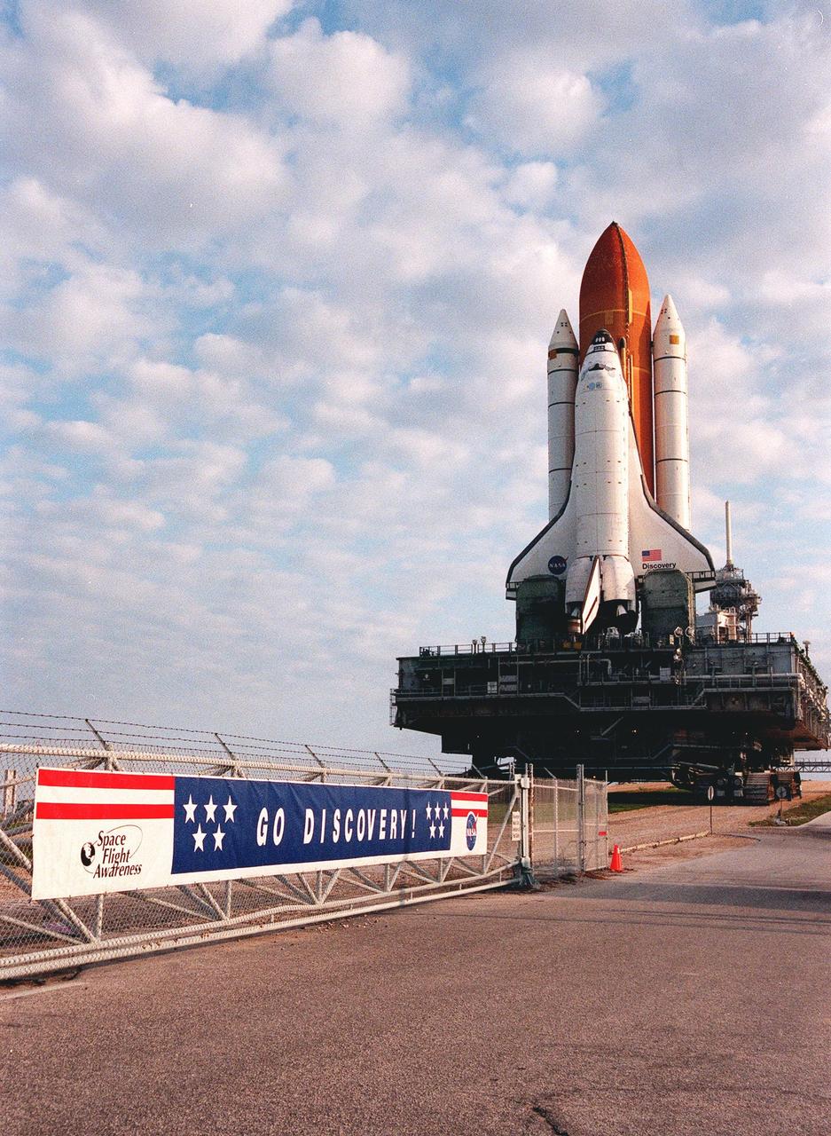 KENNEDY SPACE CENTER, FLA. -- Nearing the end of its 4.2-mile trek from the Vehicle Assembly Building (VAB), Space Shuttle Discovery clears the gate to begin the climb to Launch Pad 39B aboard the mobile launcher platform and crawler transporter. Earlier in the week, the Shuttle was rolled back to the VAB from the pad to repair hail damage on the external tank's foam insulation. Mission STS-96, the 94th launch in the Space Shuttle Program, is scheduled for liftoff May 27 at 6:48 a.m. EDT. STS-96 is a logistics and resupply mission for the International Space Station, carrying such payloads as a Russian crane, the Strela; a U.S.-built crane; the Spacehab Oceaneering Space System Box (SHOSS), a logistics items carrier; and STARSHINE, a student-shared experiment