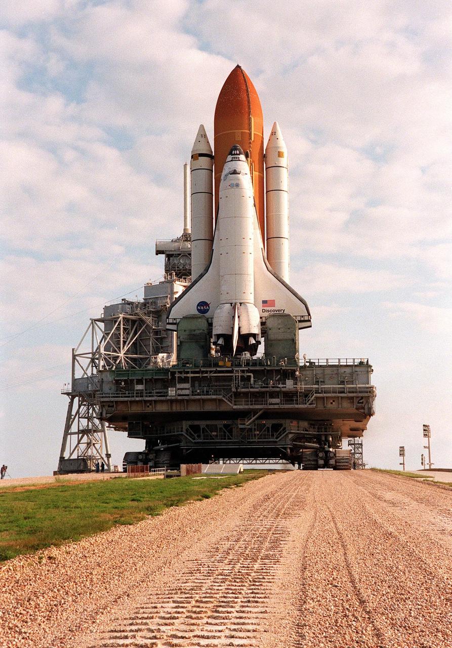 KENNEDY SPACE CENTER, FLA. -- The crawler transporter, with its cargo of Space Shuttle Discovery and mobile launcher platform, leaves tracks on the crawlerway as it makes its way up Launch Pad 39B. Behind the Shuttle can be seen part of the rotating service structure and the 82-foot lightning mast (next to the solid rocket booster) on top of the fixed service structure. The two structures are used during prelaunch preparations at the pad. Earlier in the week, the Shuttle was rolled back to the VAB from the pad to repair hail damage on the external tank's foam insulation. Mission STS-96, the 94th launch in the Space Shuttle Program, is scheduled for liftoff May 27 at 6:48 a.m. EDT. STS-96 is a logistics and resupply mission for the International Space Station, carrying such payloads as a Russian crane, the Strela; a U.S.-built crane; the Spacehab Oceaneering Space System Box (SHOSS), a logistics items carrier; and STARSHINE, a student-shared experiment