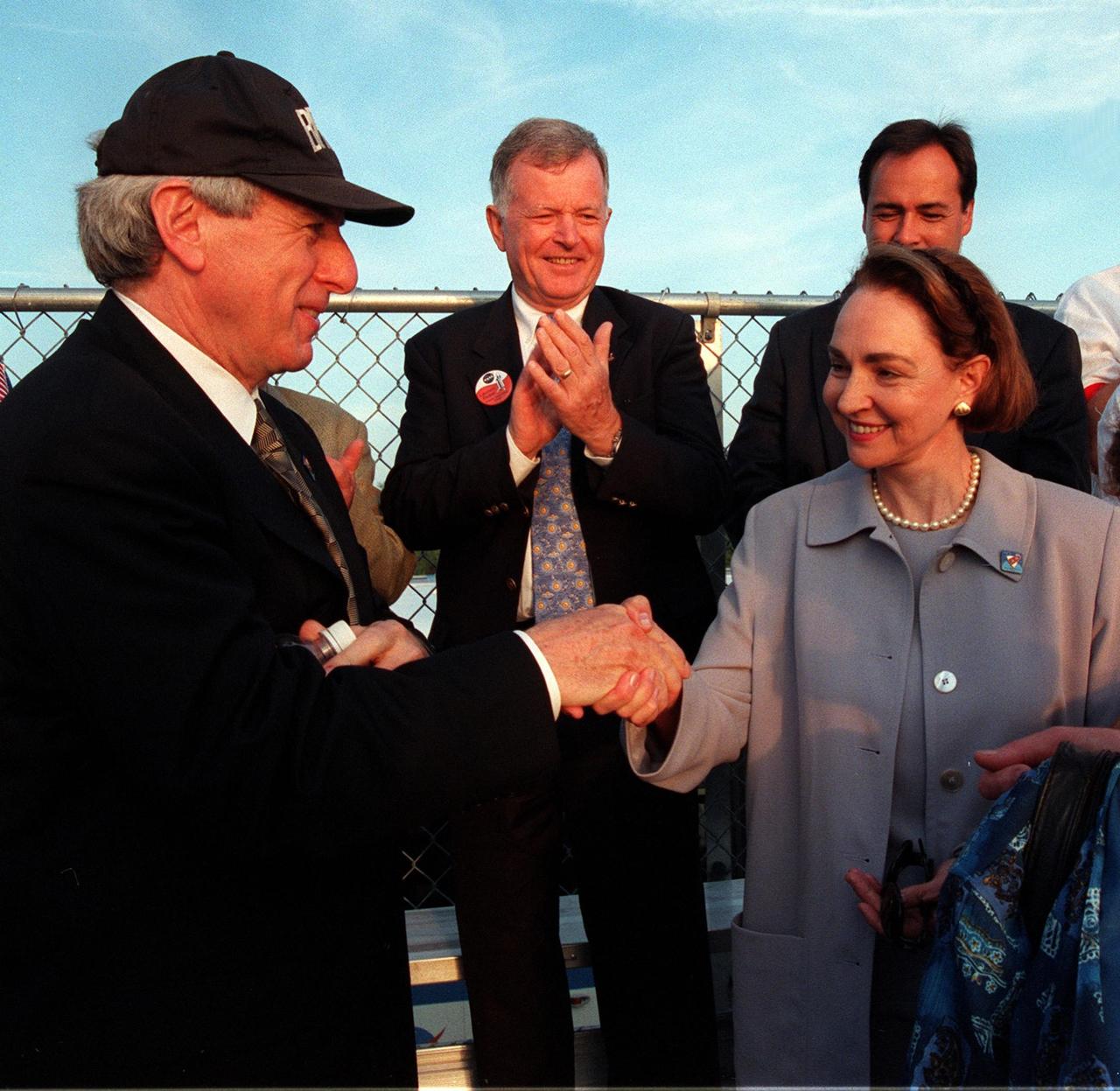 NASA Administrator Daniel Goldin (left) greets Mme. Aline Chretien, wife of the Canadian Prime Minister, at the launch of STS-96. Looking on in the background (between them) is former astronaut Jean-Loup Chretien (no relation), who flew on STS-86. Mme. Chretien attended the launch because one of the STs-96 crew is Mission Specialist Julie Payette, who represents the Canadian Space Agency. Space Shuttle Discovery launched on time at 6:49:42 a.m. EDT to begin a 10-day logistics and resupply mission for the International Space Station. Along with such payloads as a Russian crane, the Strela; a U.S.-built crane; the Spacehab Oceaneering Space System Box (SHOSS), a logistics items carrier; and STARSHINE, a student-involved experiment, Discovery carries about 4,000 pounds of supplies, to be stored aboard the station for use by future crews, including laptop computers, cameras, tools, spare parts, and clothing. The mission includes a space walk to attach the cranes to the outside of the ISS for use in future construction. Landing is expected at the SLF on June 6 about 1:58 a.m. EDT