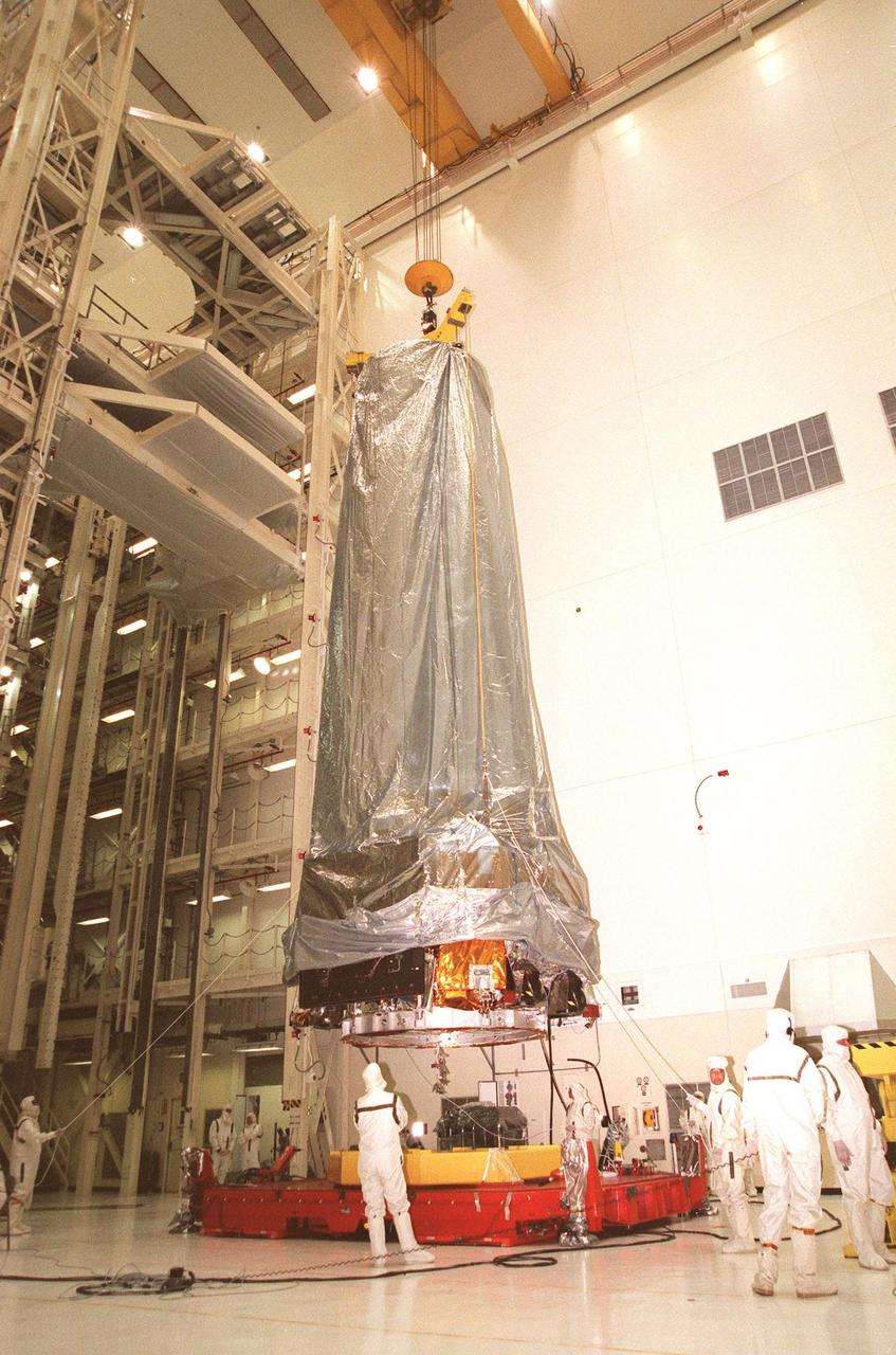 In the Vertical Processing Facility, the Chandra X-ray Observatory is lifted from its workstand in order to move it to the Inertial Upper Stage (IUS) nearby. After being mated, the two components will then undergo testing to validate the IUS/Chandra connections and check the orbiter avionics interfaces. Following that, an end-to-end test (ETE) will be conducted to verify the communications path to Chandra, commanding it as if it were in space. With the world's most powerful X-ray telescope, Chandra will allow scientists from around the world to see previously invisible black holes and high-temperature gas clouds, giving the observatory the potential to rewrite the books on the structure and evolution of our universe. Chandra is scheduled for launch July 22 aboard Space Shuttle Columbia, on mission STS-93